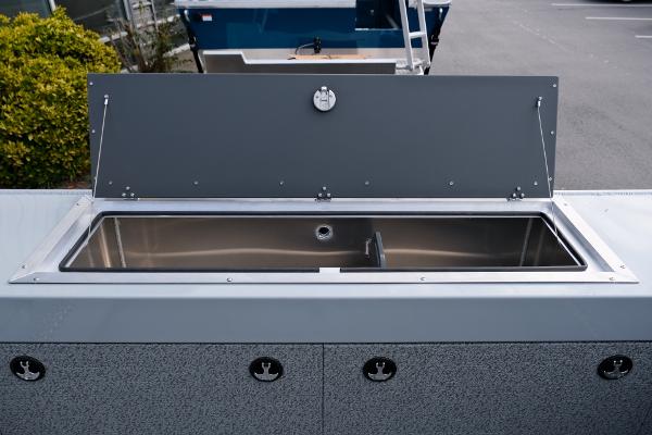 2024 Hewescraft 180 Pro-V ET boat with open storage compartment.