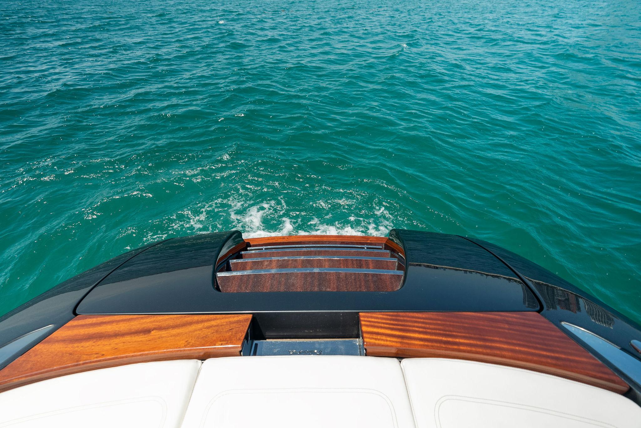2022 Riva 38 Rivamare yacht stern view on clear blue water.