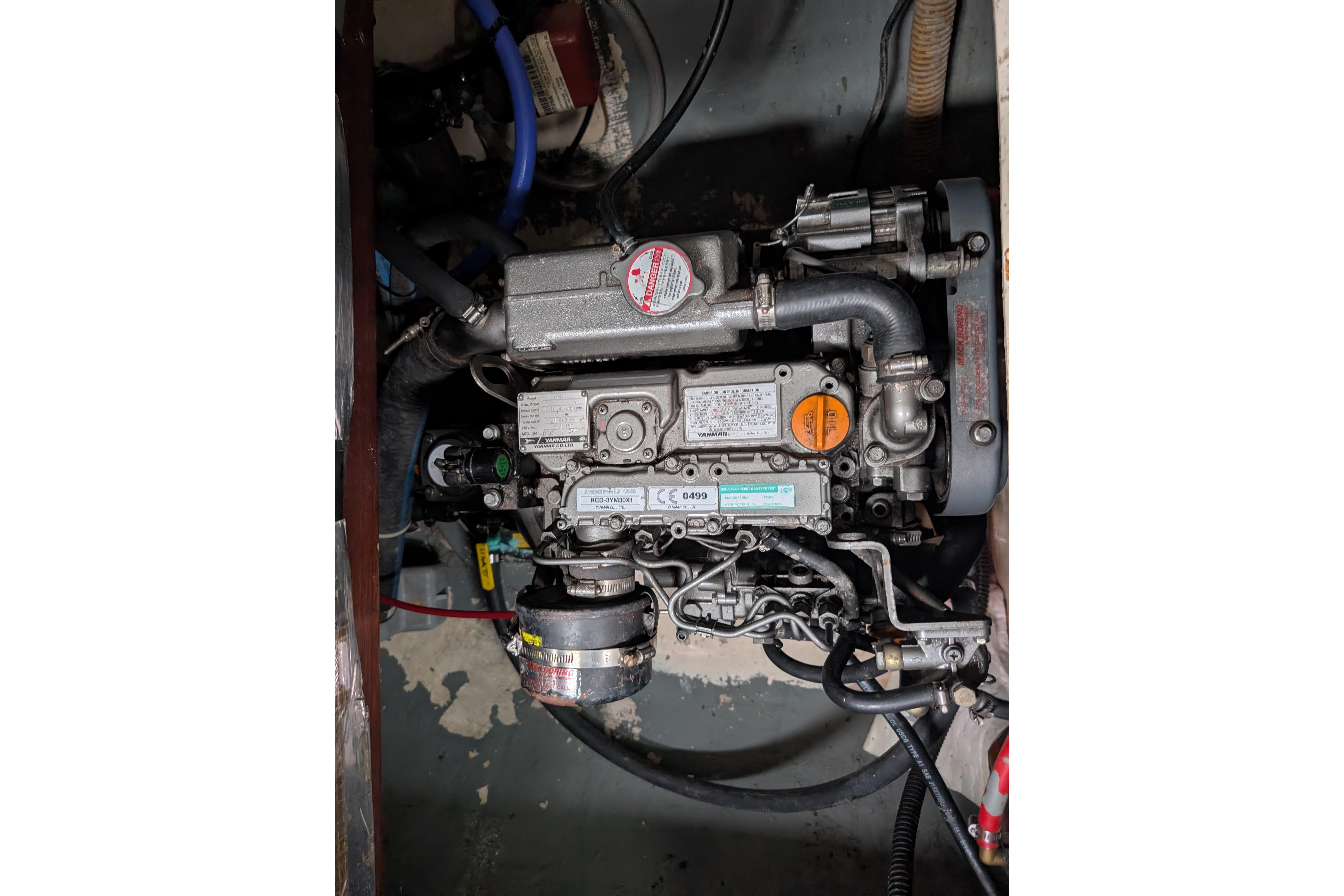 Engine compartment of a 1999 Island Spirit 37 sailboat, showcasing mechanical components.
