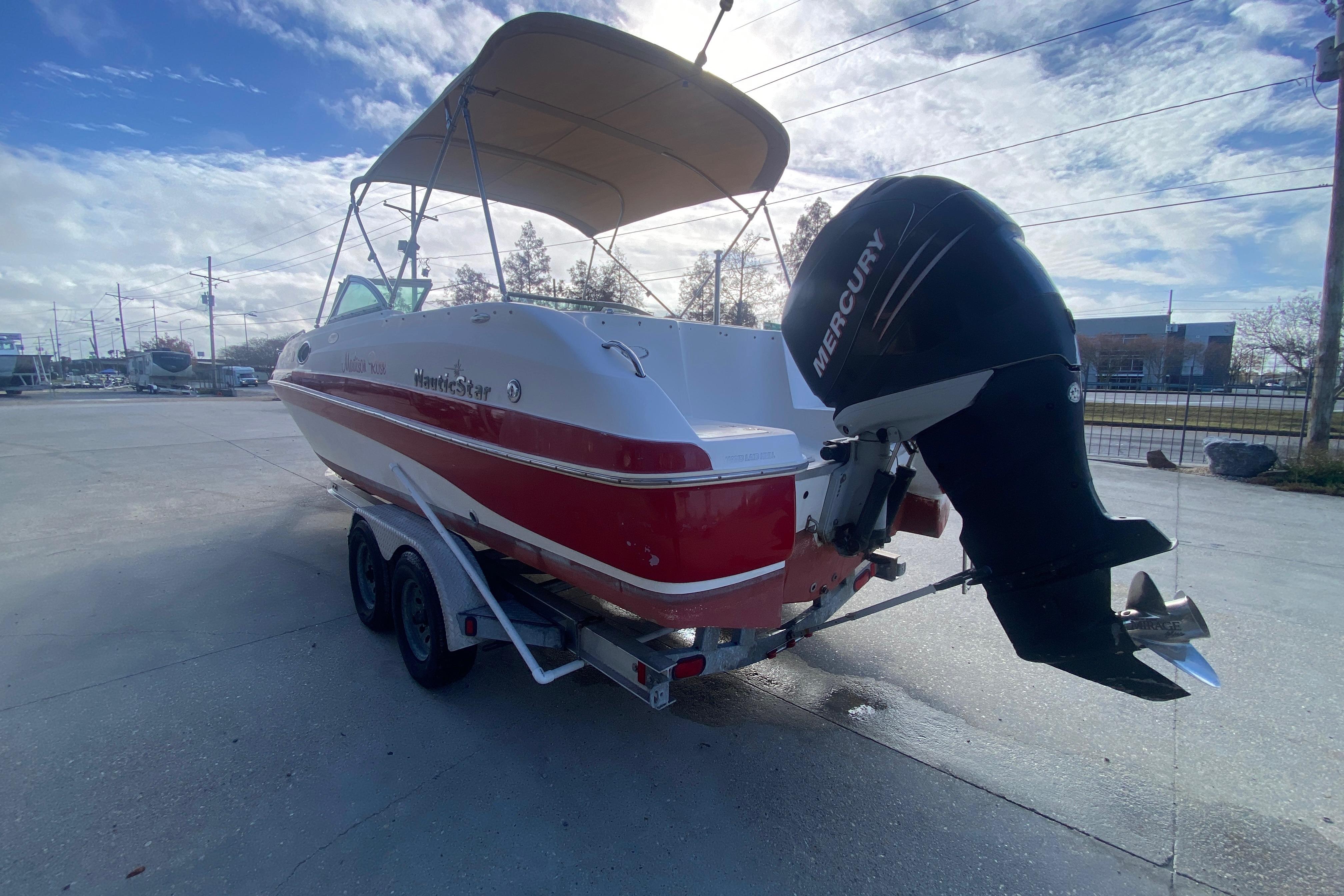 2007 NauticStar 230DC Sport Deck boat with Mercury engine on trailer.