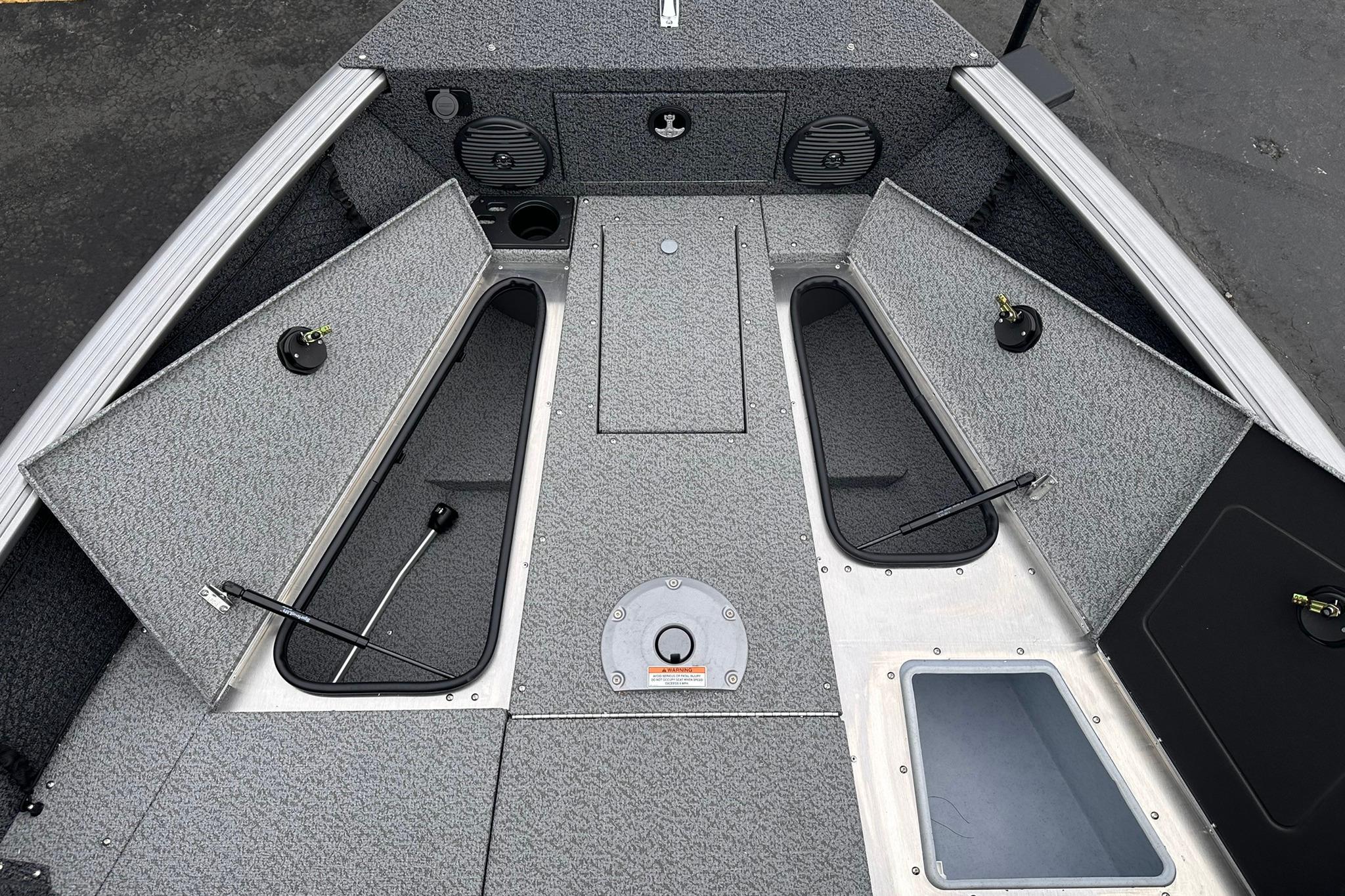 2026 Lund 1775 Impact XS Sport boat interior with open storage compartments.