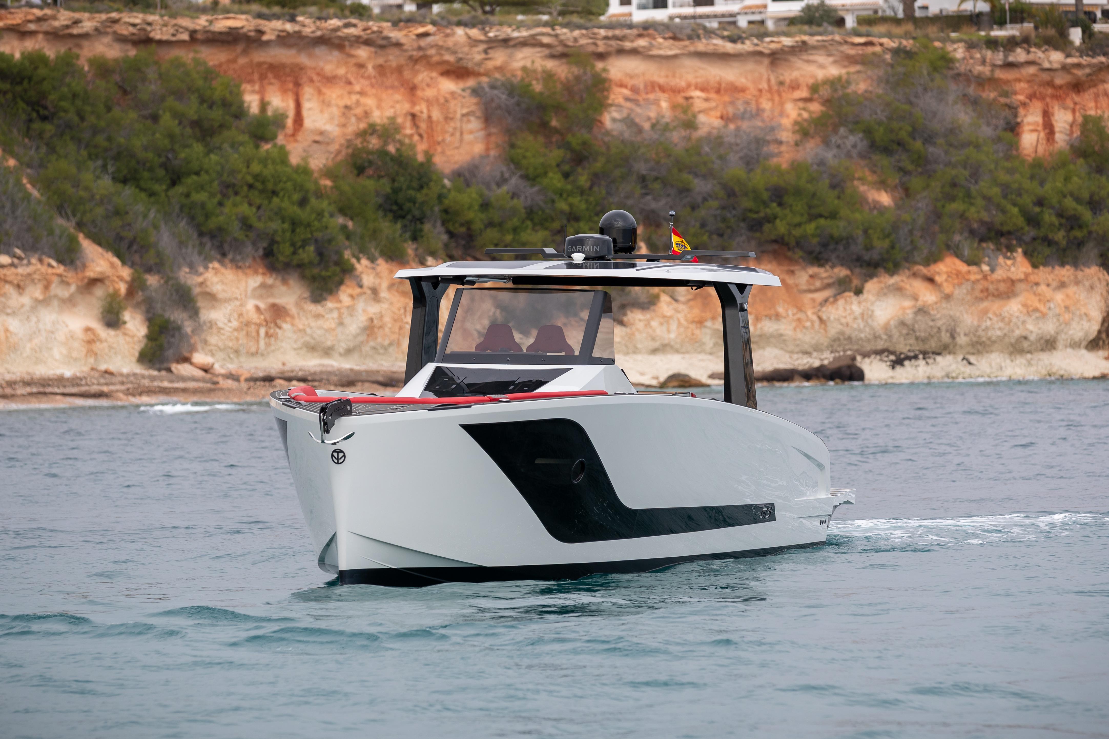 Tesoro 40 GTS 2026 yacht on the sea near rocky coastline.
