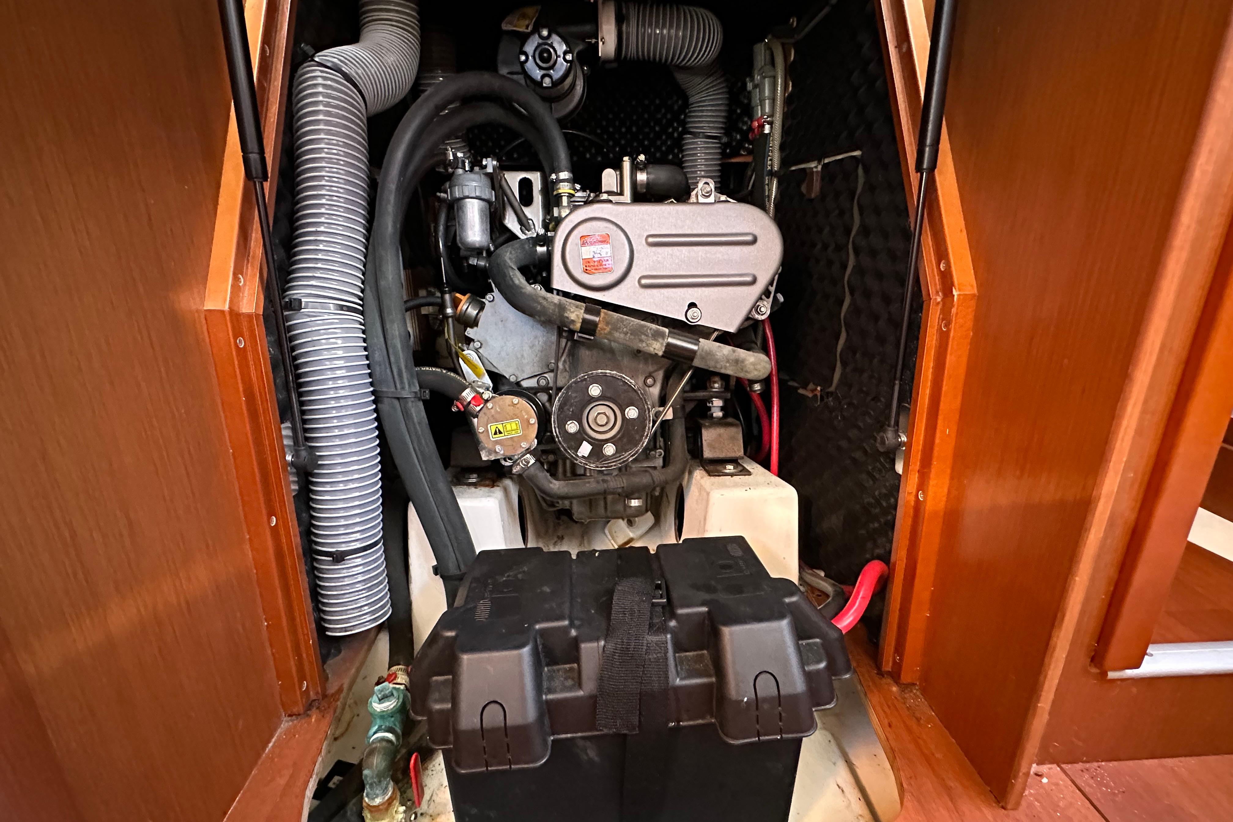Engine compartment of a 2015 Beneteau Oceanis 37 sailboat, showcasing mechanical components.