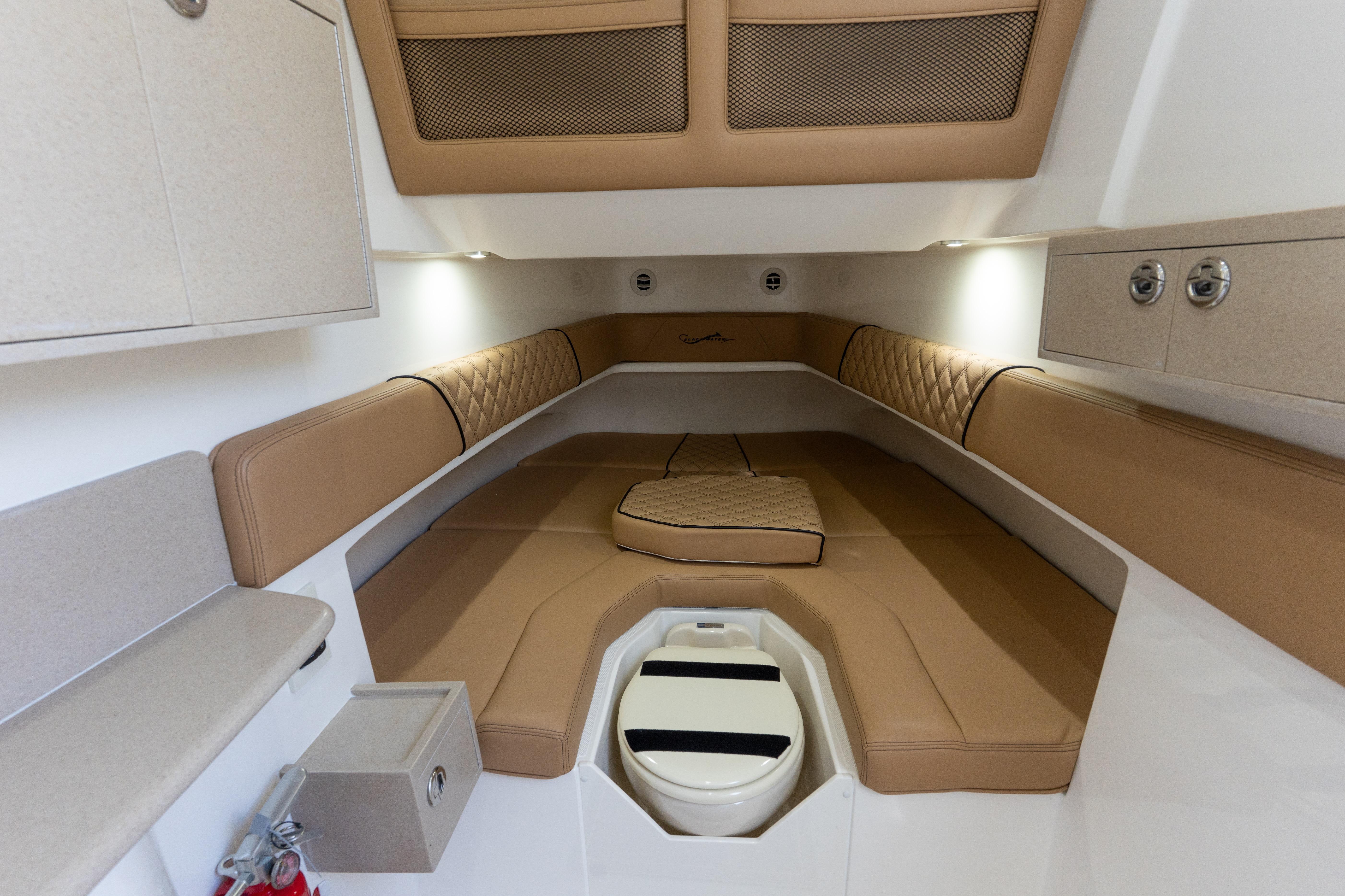 Luxurious cabin interior of 2026 Blackwater 41 Performance Fish boat with tan seating.