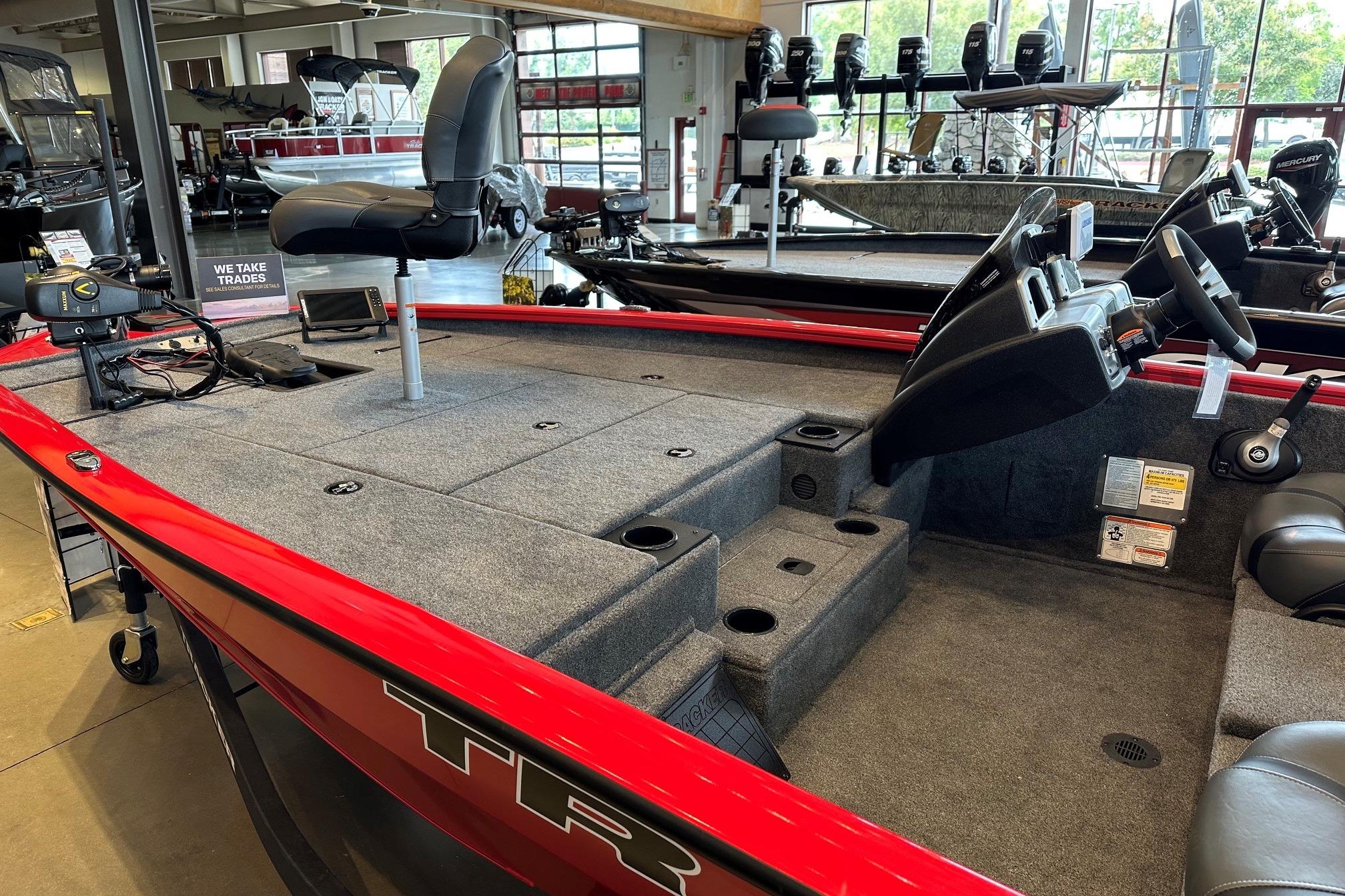 2026 Tracker Pro Team 195 boat interior with seating and controls in showroom.