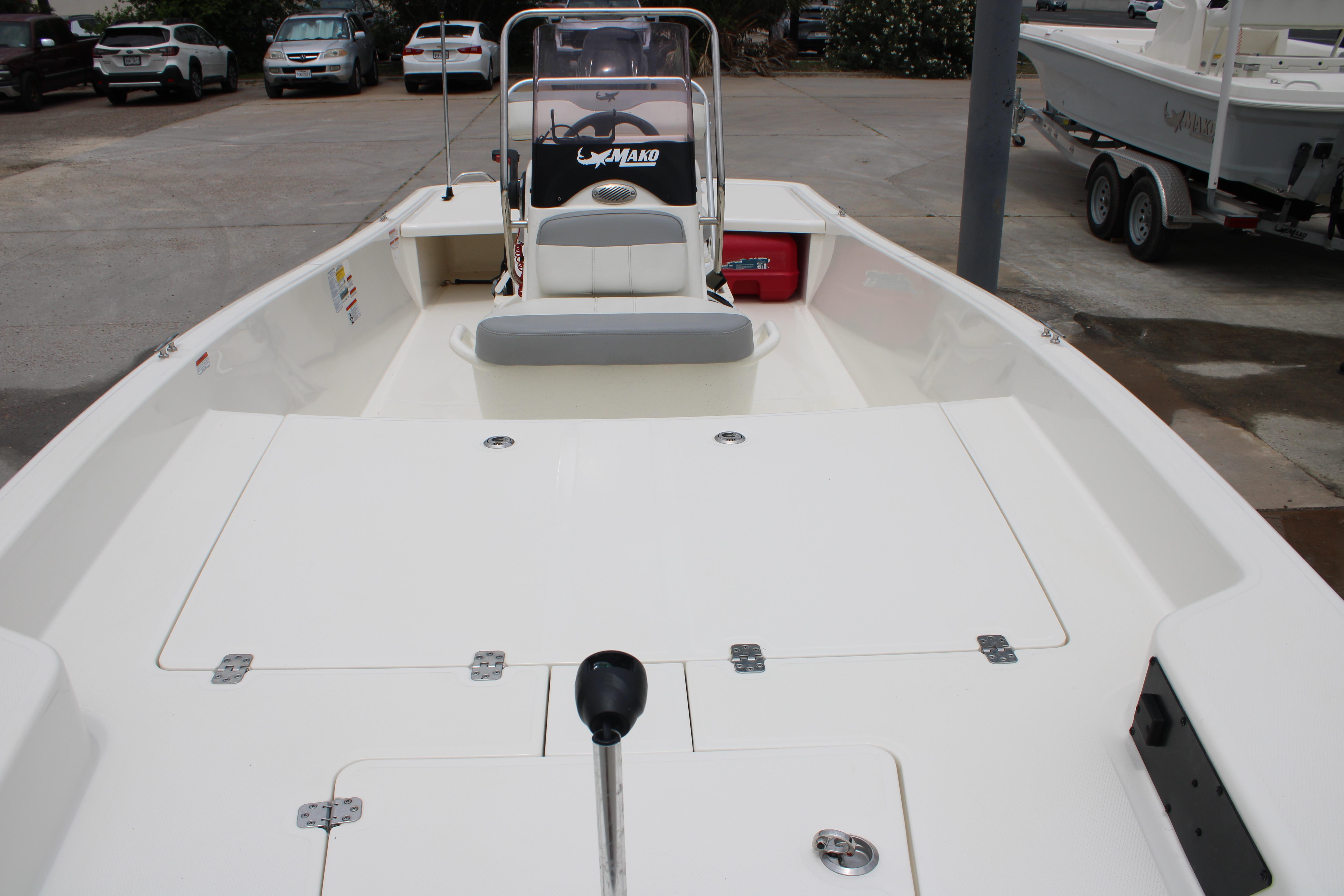 2021 Mako Pro Skiff 17 CC boat, spacious deck, parked outdoors.