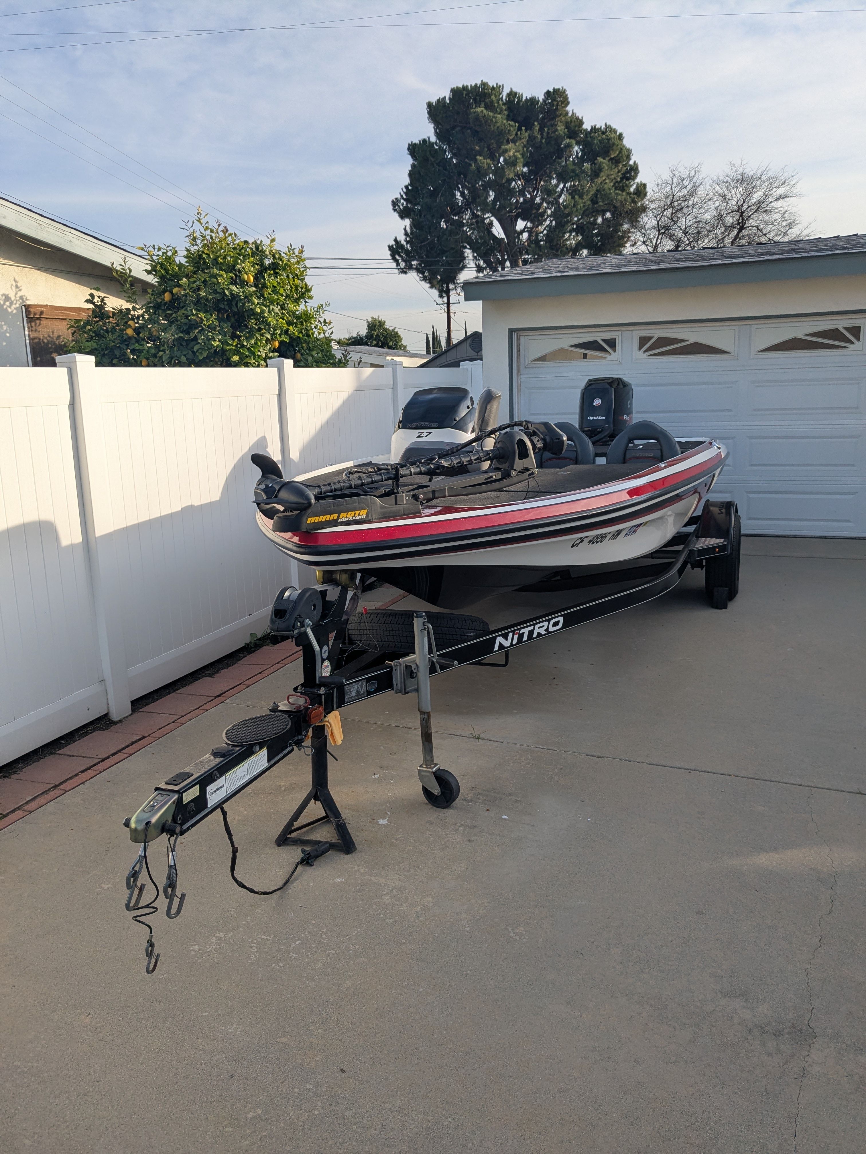 A 2014 Nitro Z-7 boat on a trailer in a driveway.