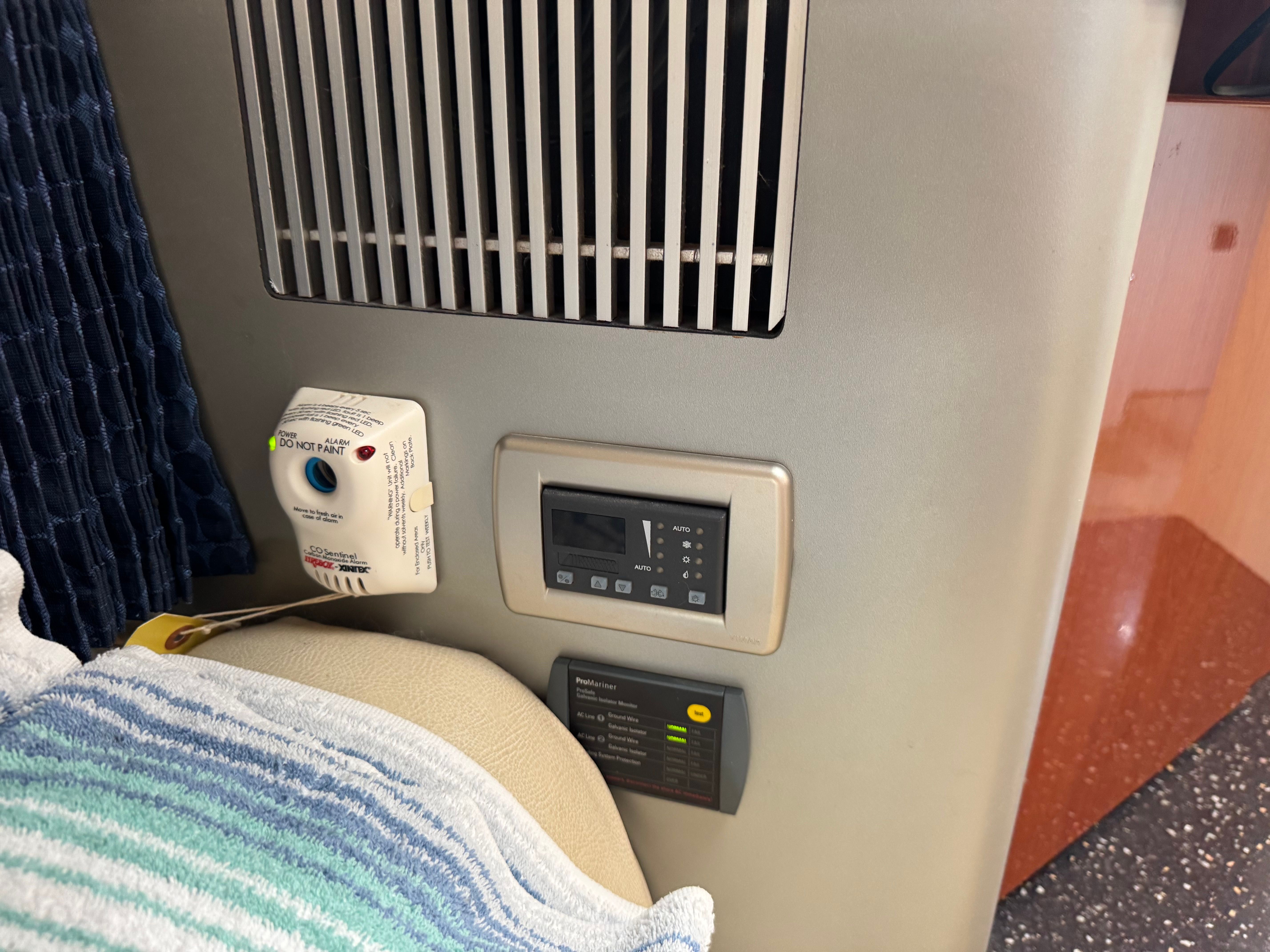 Interior of a boat with a vent and control panel.