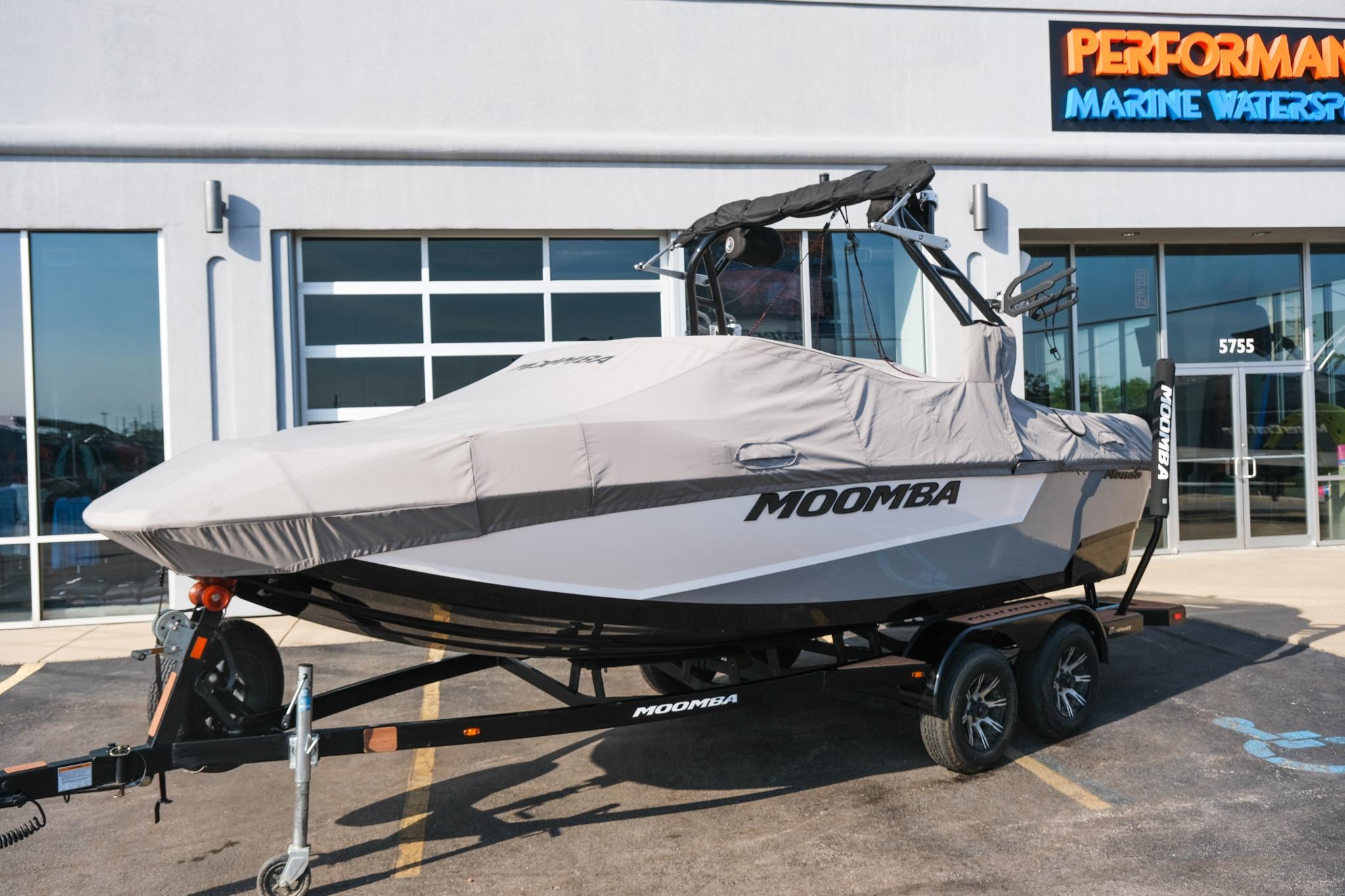 2023 Moomba Mondo boat covered on trailer outside marine dealership.