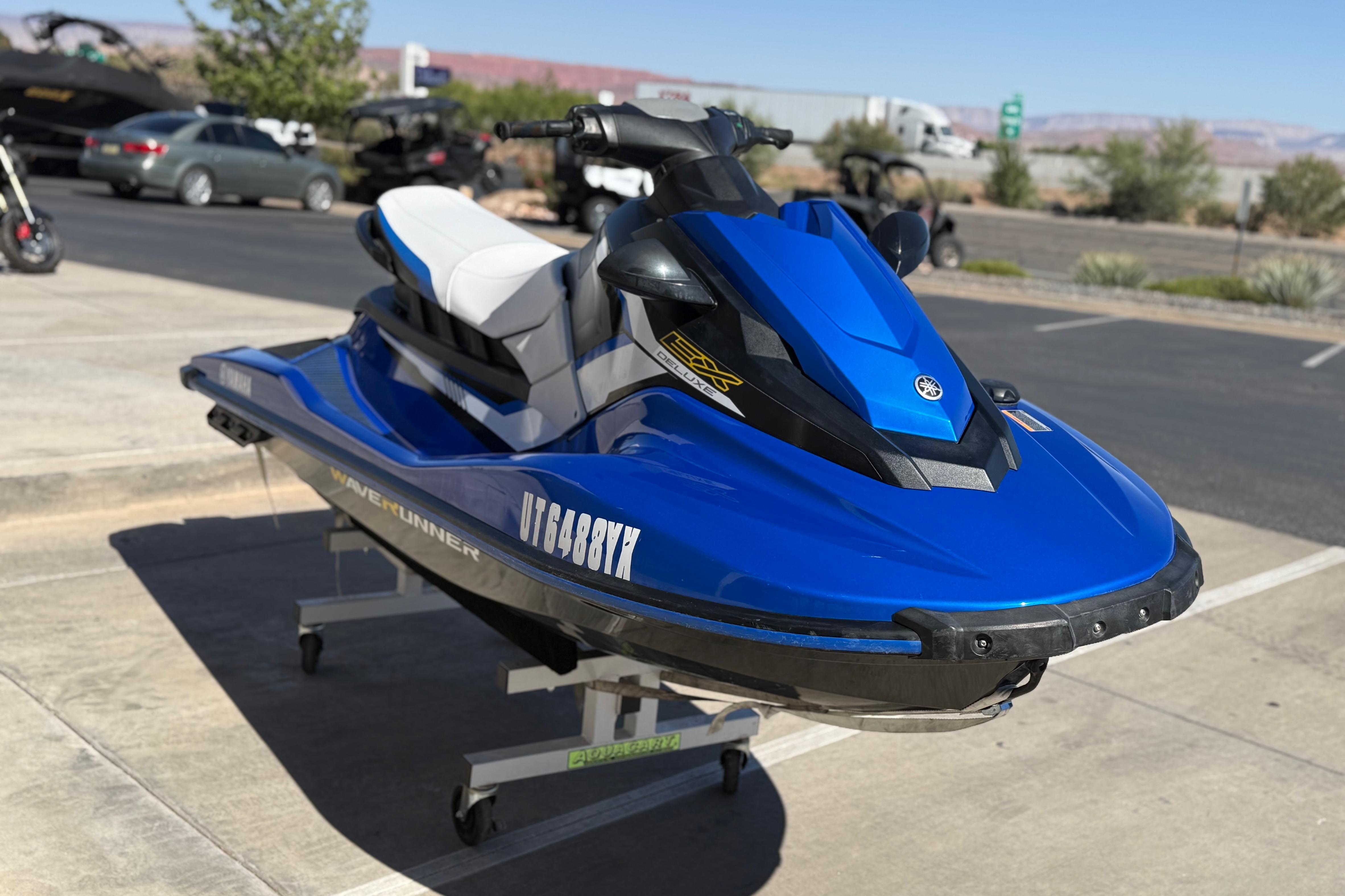 2017 Yamaha WaveRunner EX Deluxe in vibrant blue, parked outdoors on a sunny day.