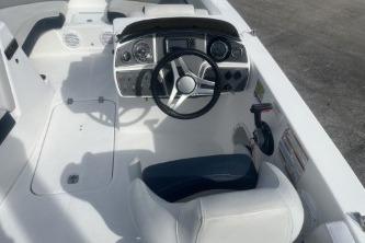 2022 Hurricane SunDeck 192 OB boat interior with steering wheel and seating.