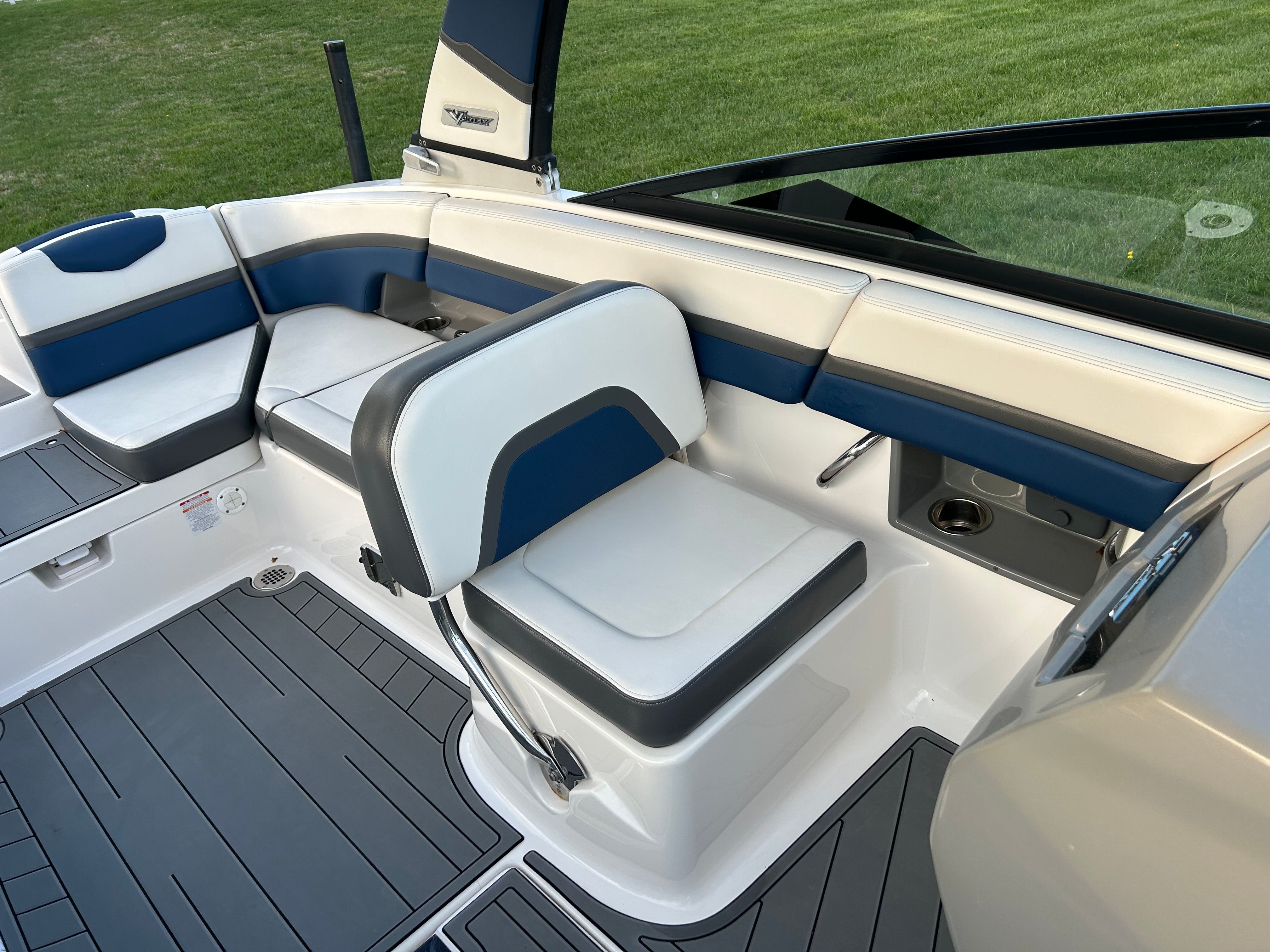 Interior of 2015 Chaparral Vortex 243 VRX with blue and white seating.