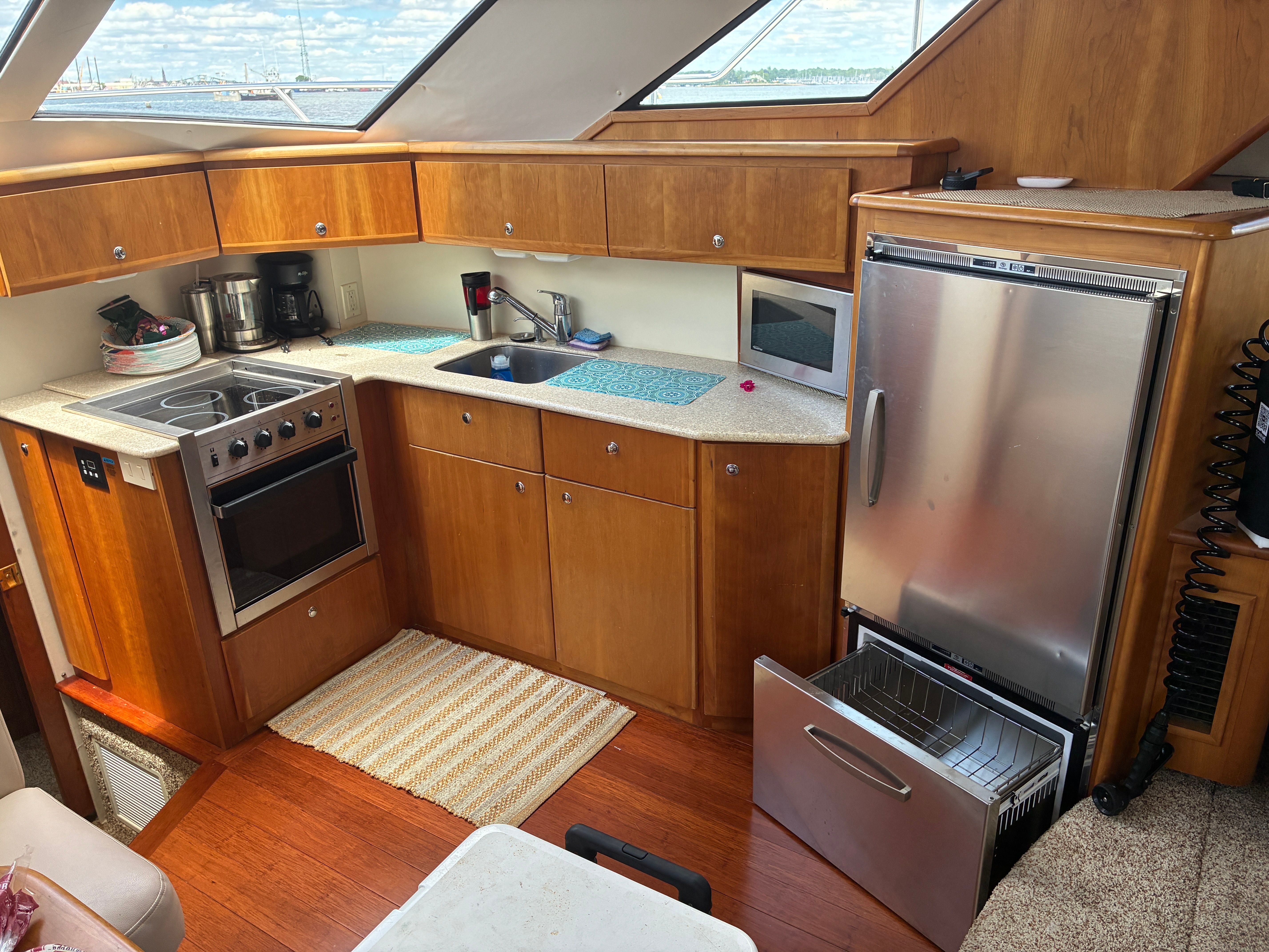 Interior of the 2001 Silverton 392 Motor Yacht with kitchen, stove, sink, and refrigerator.