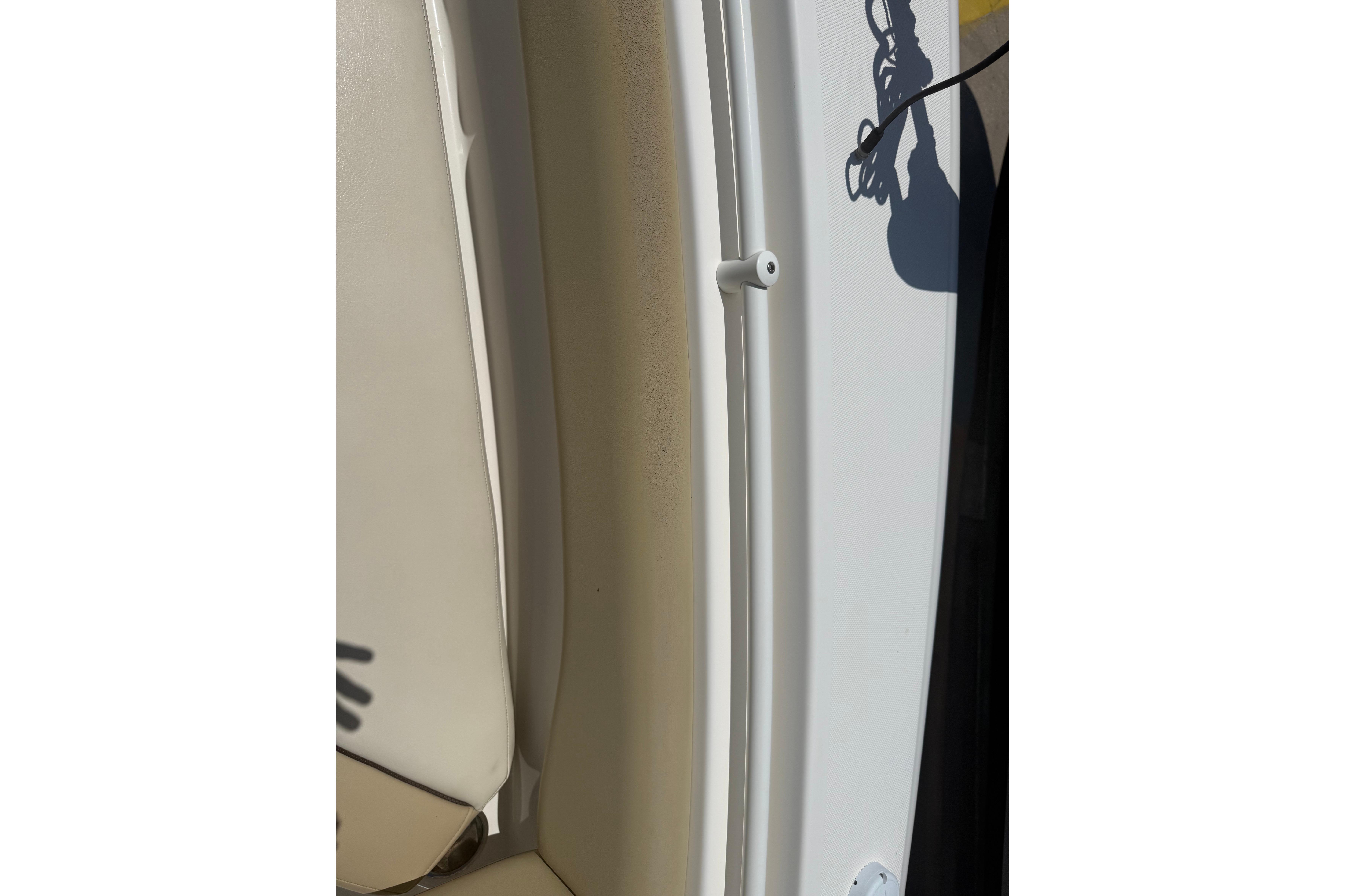 2019 Key West Billistic 281 Center Console interior detail with shadow and beige seating.
