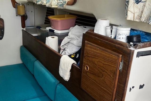 Interior of a 1979 Pearson 365 Ketch sailboat with storage and seating area.