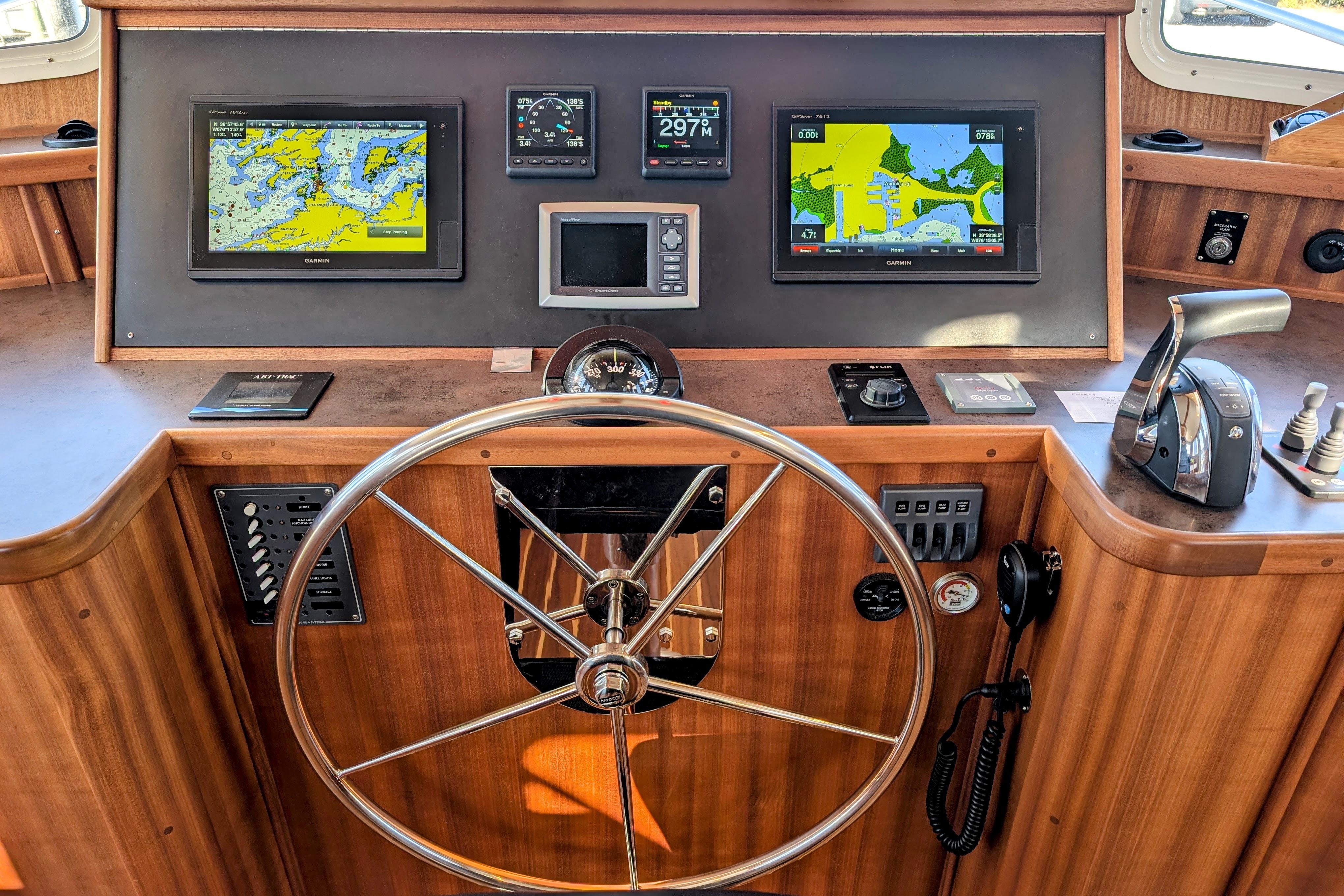 American Tug 435 helm, 2015 model, featuring navigation screens and controls.