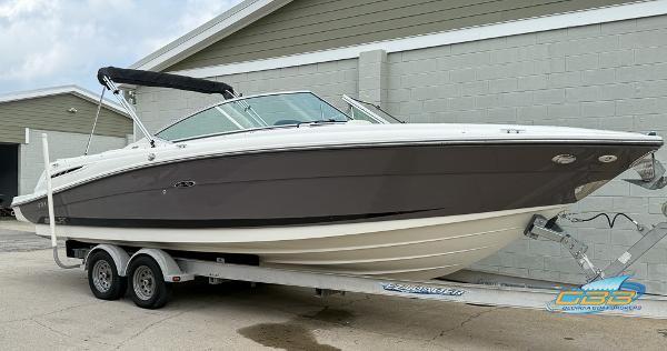 2008 Sea Ray 270 SLX boat on trailer, parked outside a building.