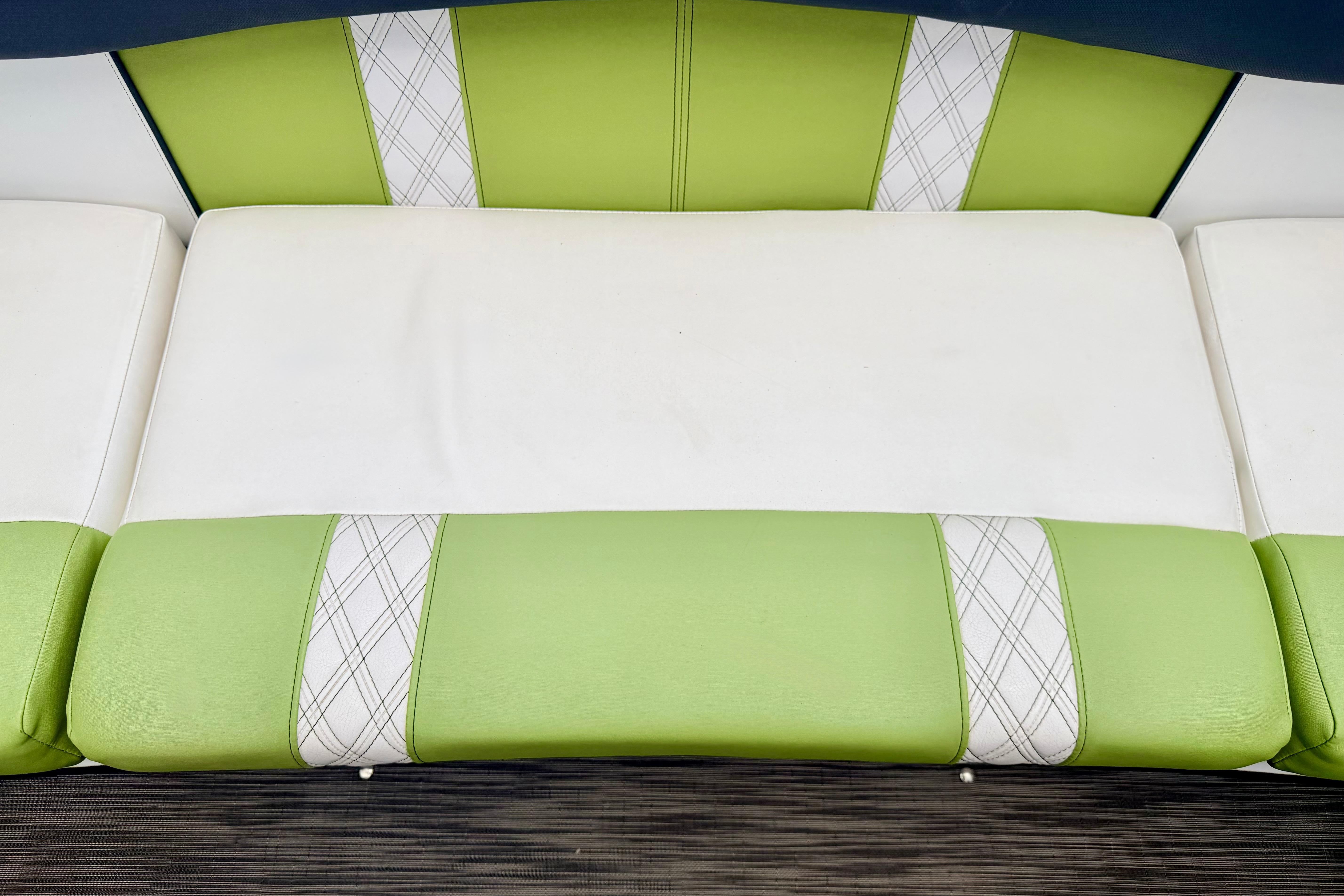 Green and white seating on 2018 Glastron GT 185 boat, featuring plaid accents.