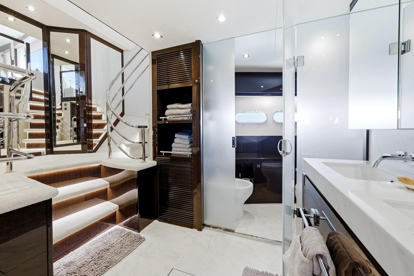 Luxurious 2022 Sunseeker Motoryacht interior with elegant staircase and modern bathroom design.
