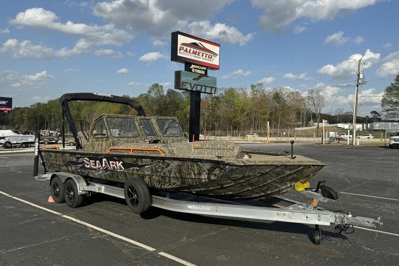 2026 SeaArk EasyCat boat on trailer at dealership, under clear sky.