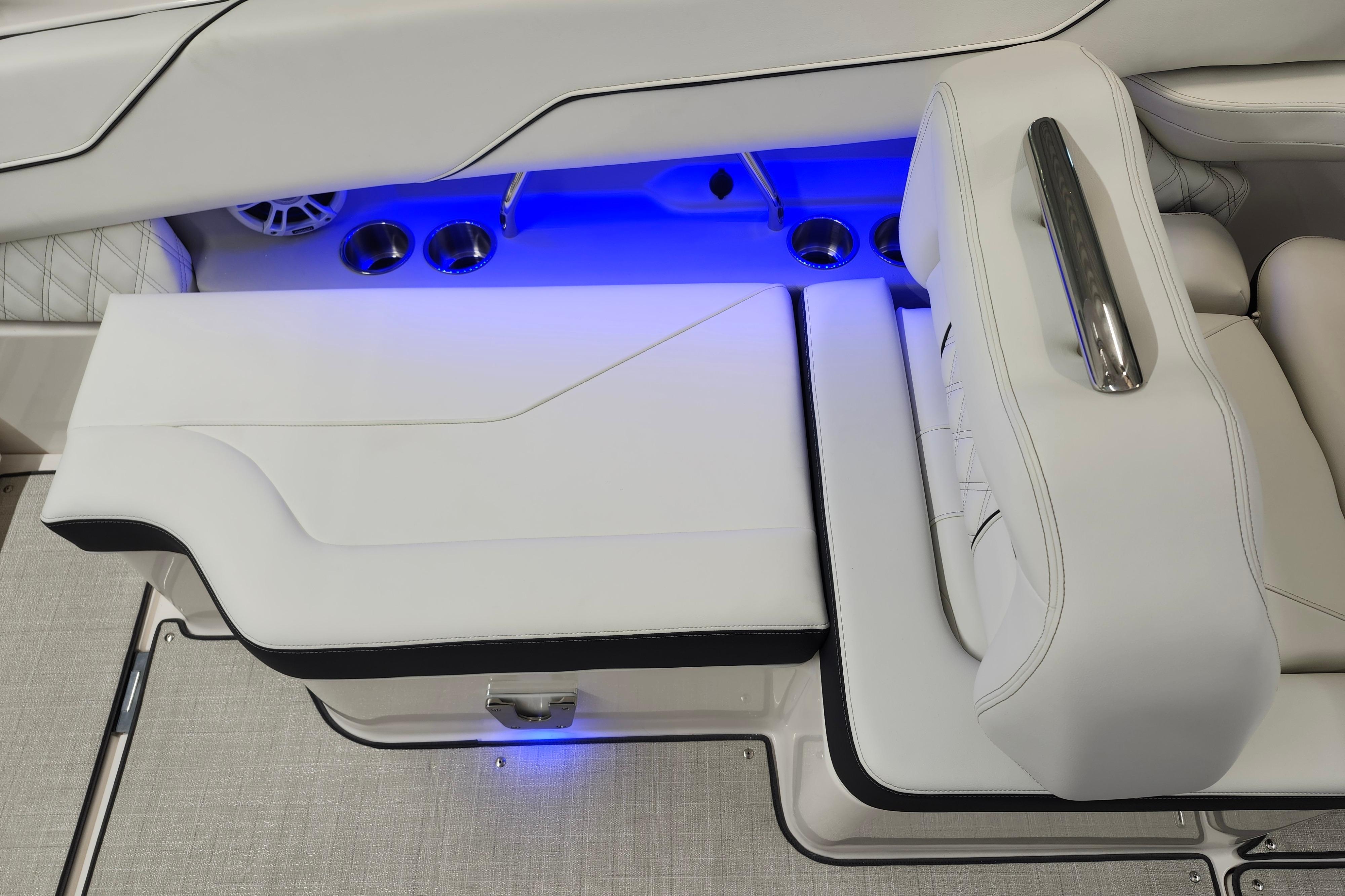 Luxurious white seating with blue LED lighting in 2025 Regal LX4 boat.