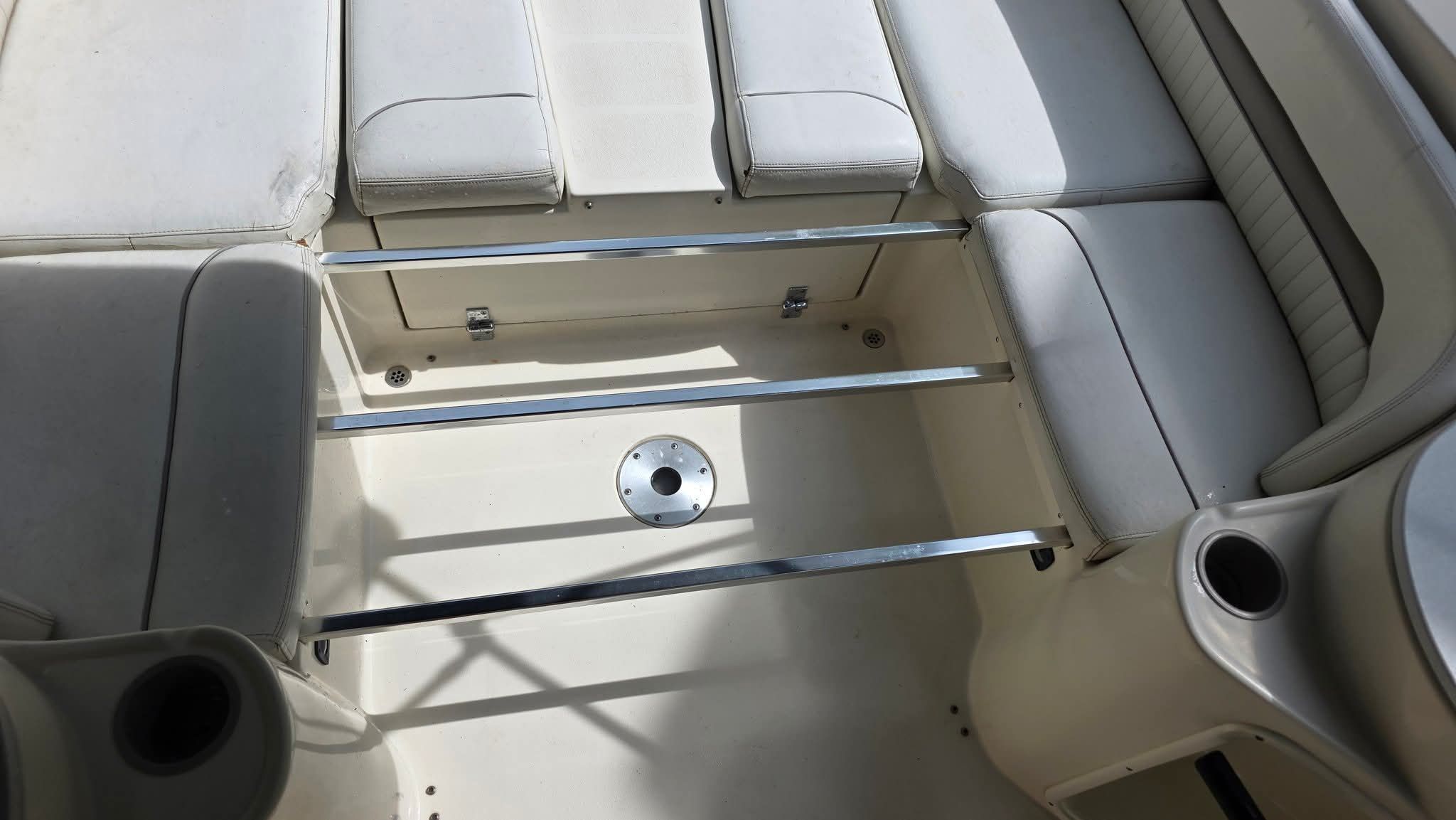 Interior of a 2006 Stingray 250 CR with white upholstery and stainless steel bars.
