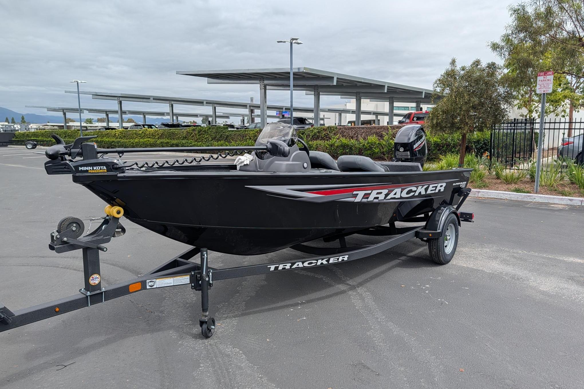 2026 Tracker Super Guide V-16 SC boat on trailer in parking lot.