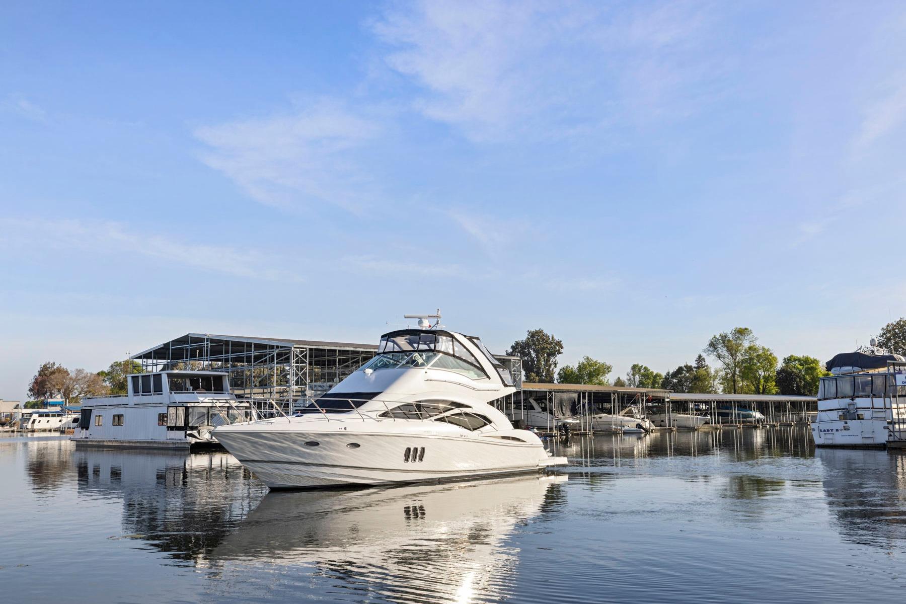 2008 Cruisers Yachts 447 Sport Sedan on calm water near marina.