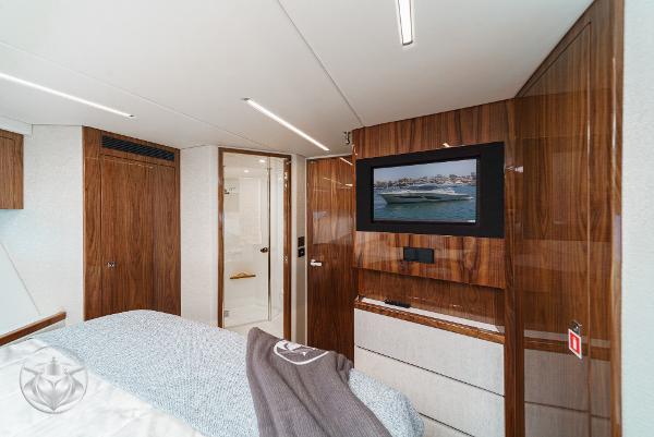 Luxurious interior of 2025 Riviera 645 SUV yacht with wood paneling and modern amenities.