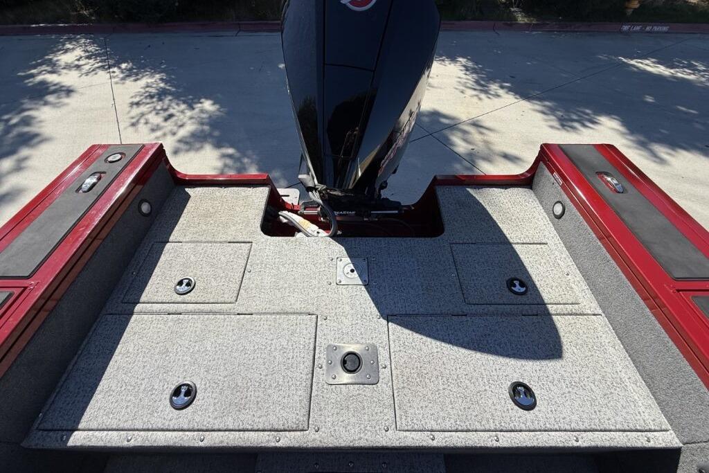 2024 Tracker Targa V-19 WT boat deck with storage compartments and motor.