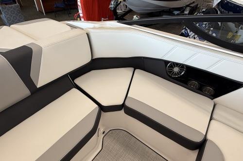 2027 Regal 2000 ES boat interior with white and black seating, speaker, and cup holders.