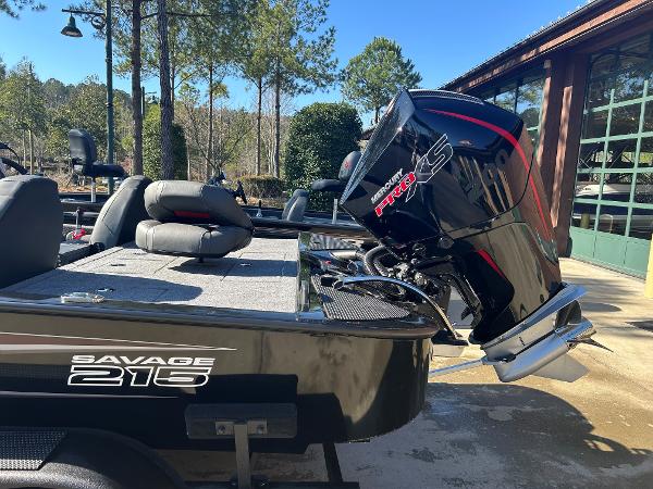 2025 Tracker Savage 215 boat with powerful outboard motor, parked outdoors.
