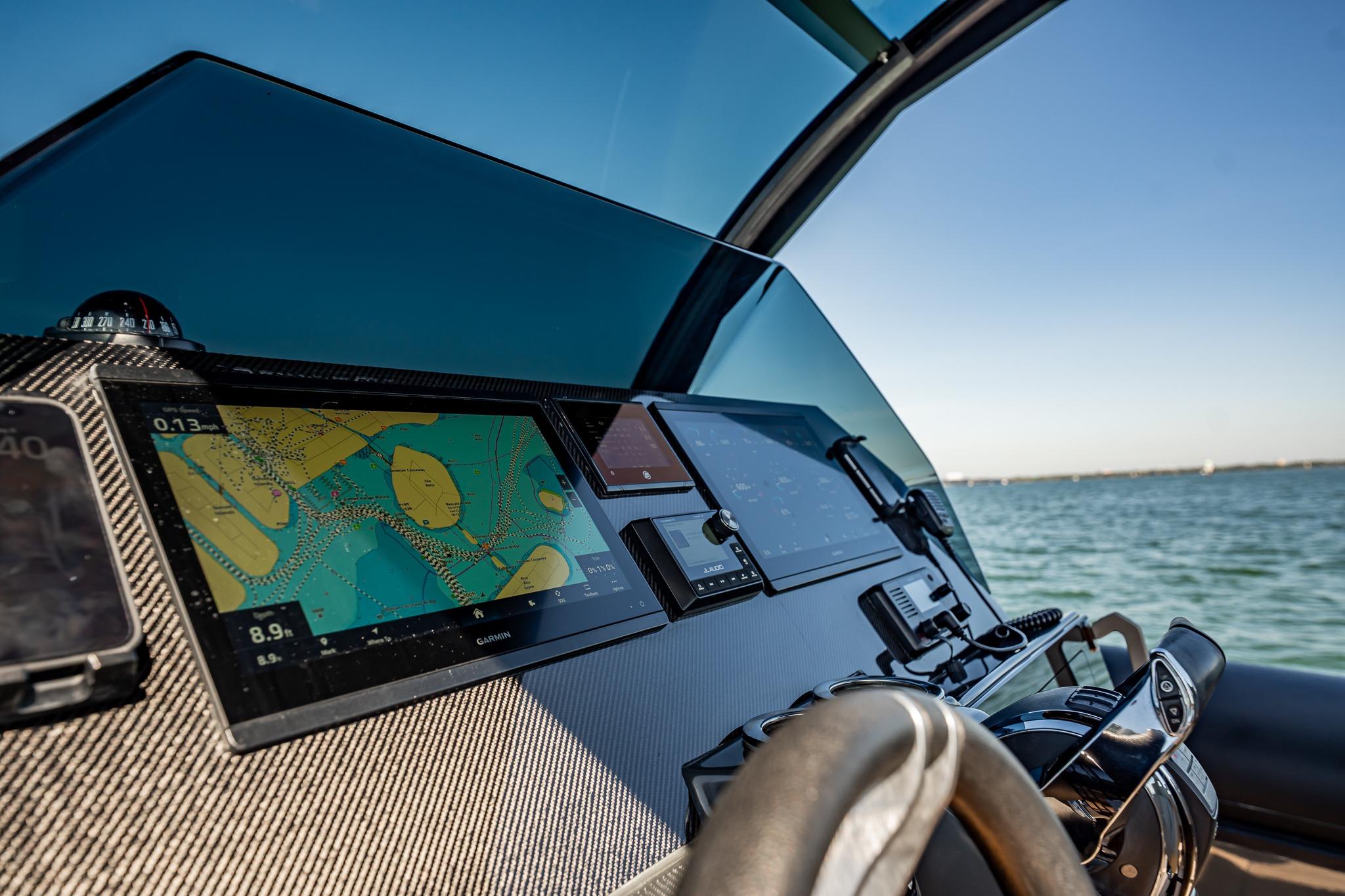 Cockpit of 2023 Skipper-BSK 38NC boat with navigation screens and steering wheel.
