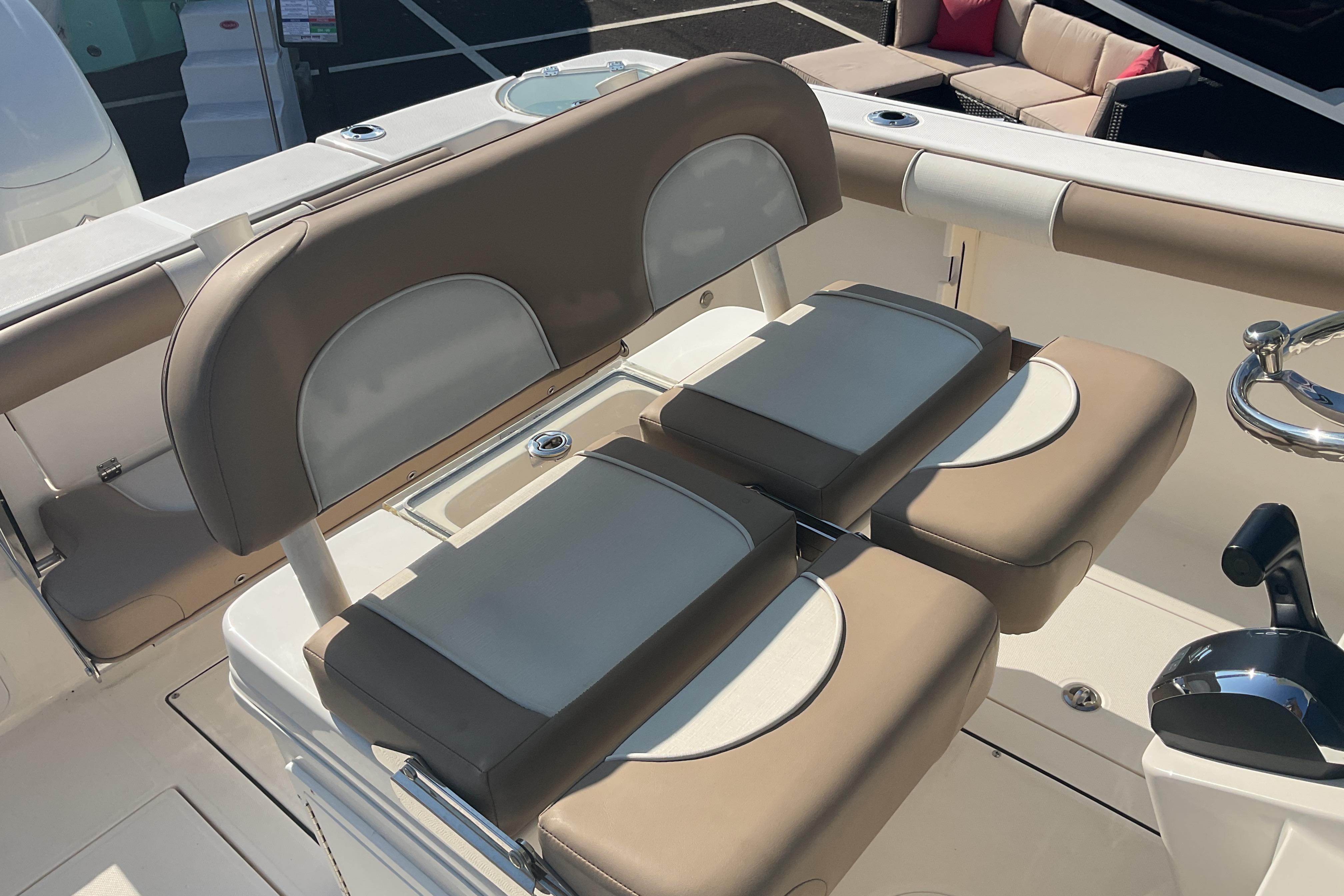 2023 Sea Born SX239 Offshore boat interior with beige seating and control panel.