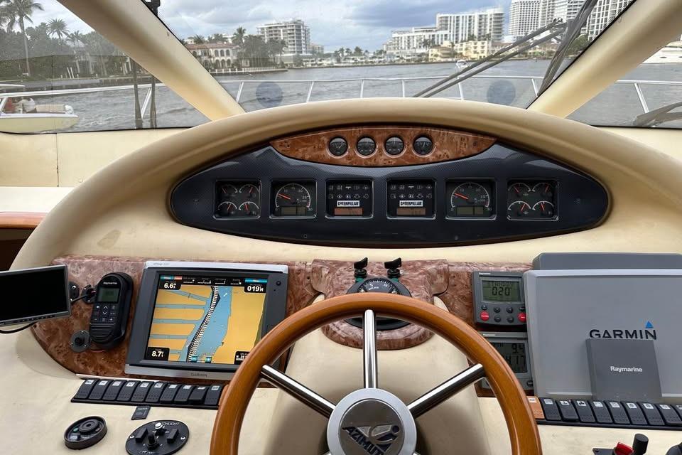 Cockpit view of a 2004 Azimut 55E yacht with navigation instruments and steering wheel.