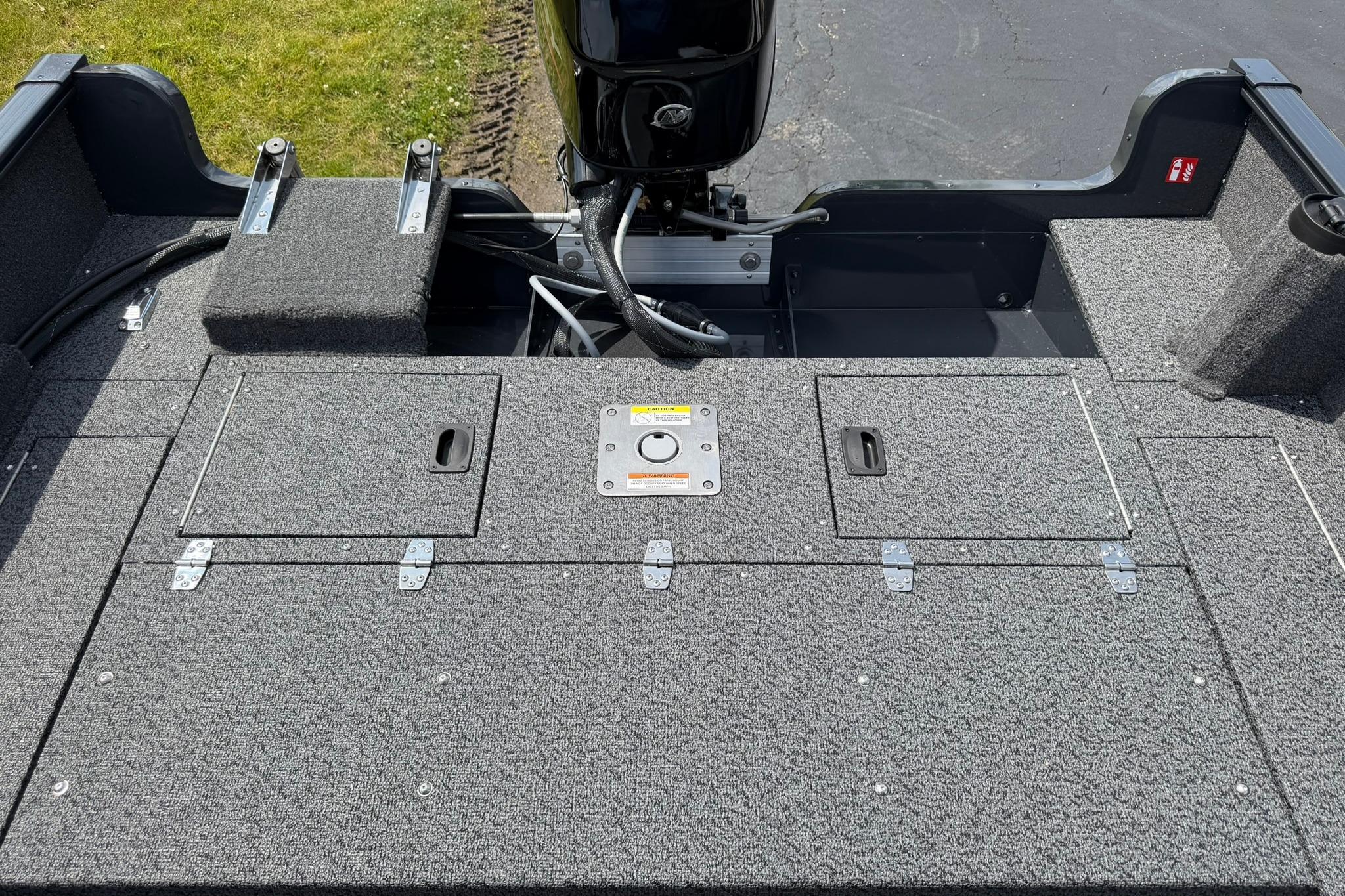 2027 Lund 1650 Rebel XL SS boat deck with storage compartments and motor.