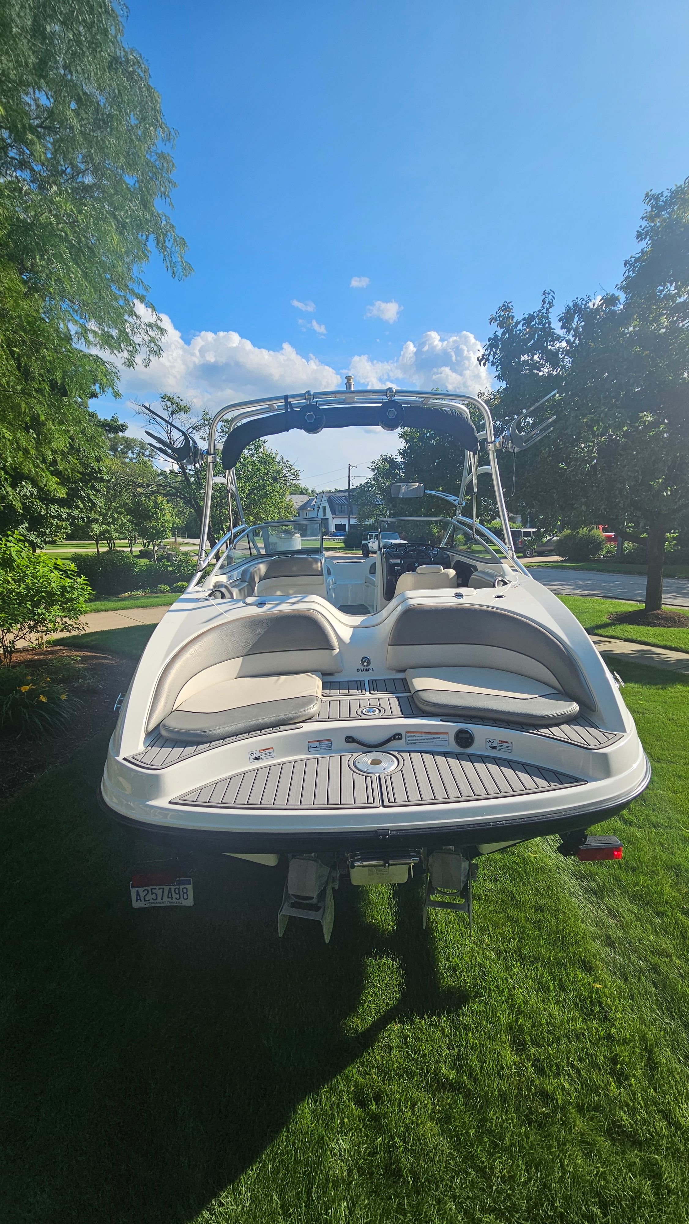 2010 Yamaha AR210 on a green lawn, surrounded by trees and a sunny sky.