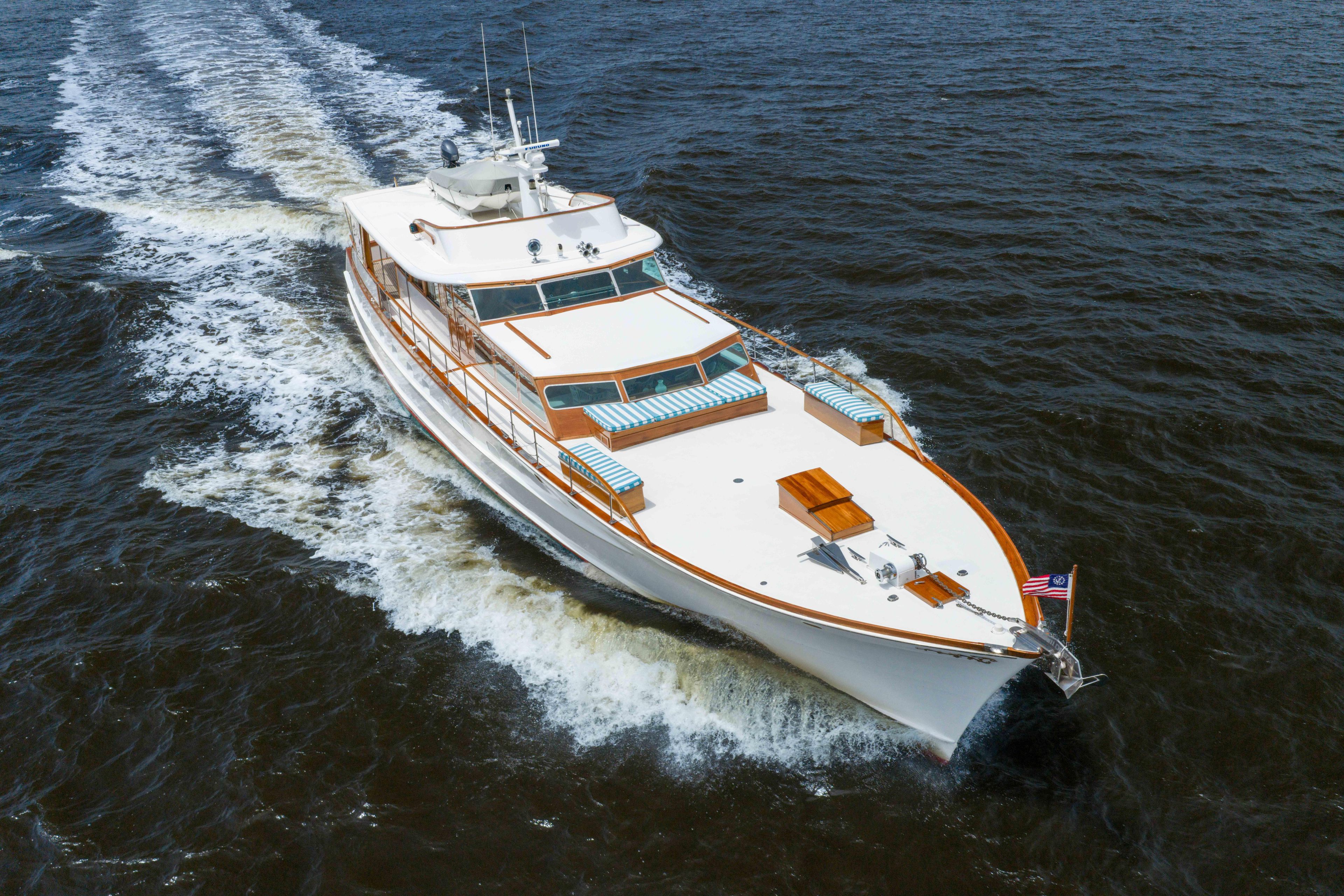 Classic 1963 Trumpy yacht cruising on open water, showcasing elegant design and craftsmanship.