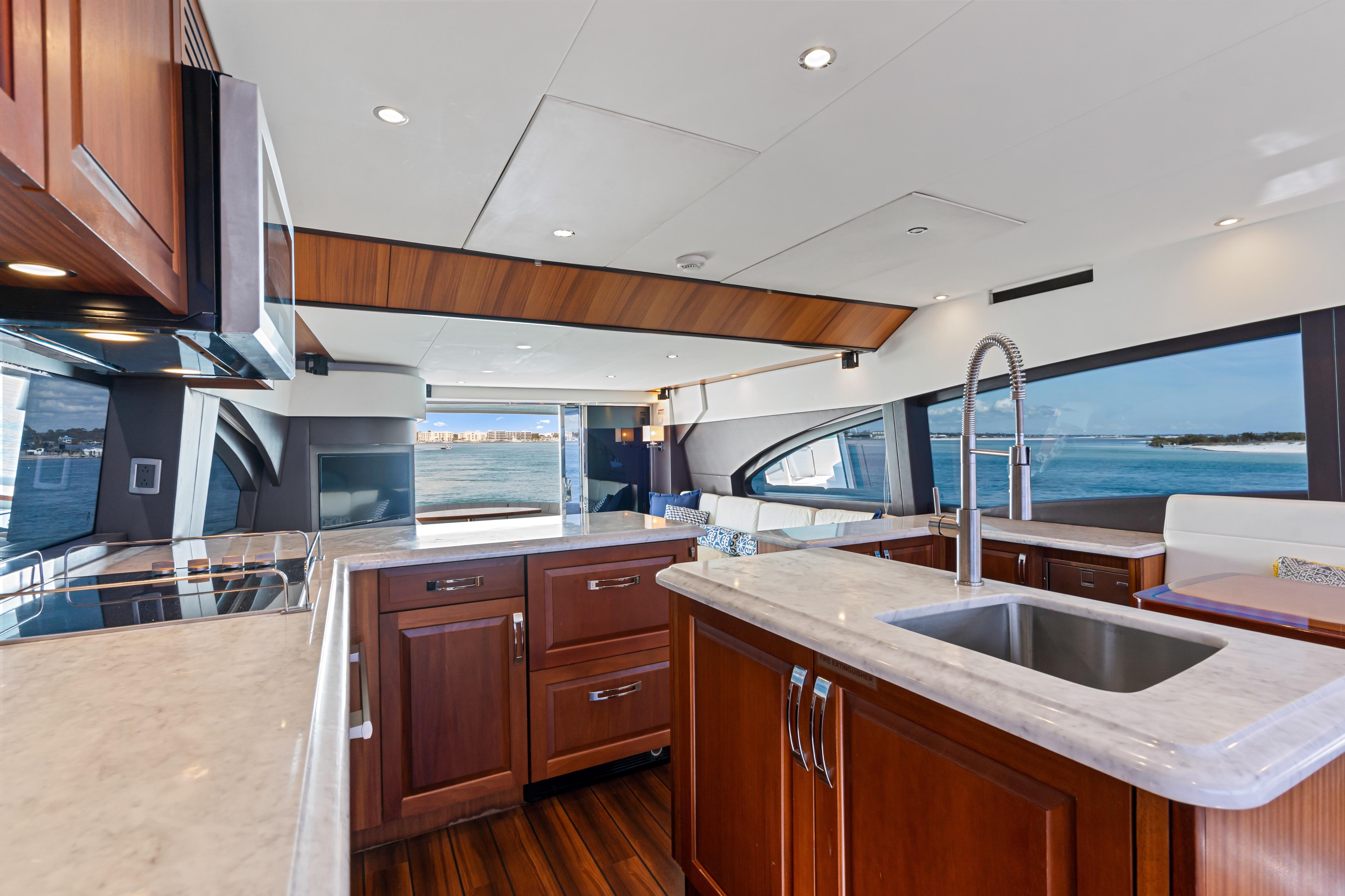 Luxurious kitchen interior of 2013 Hatteras 60 Motor Yacht with ocean view.