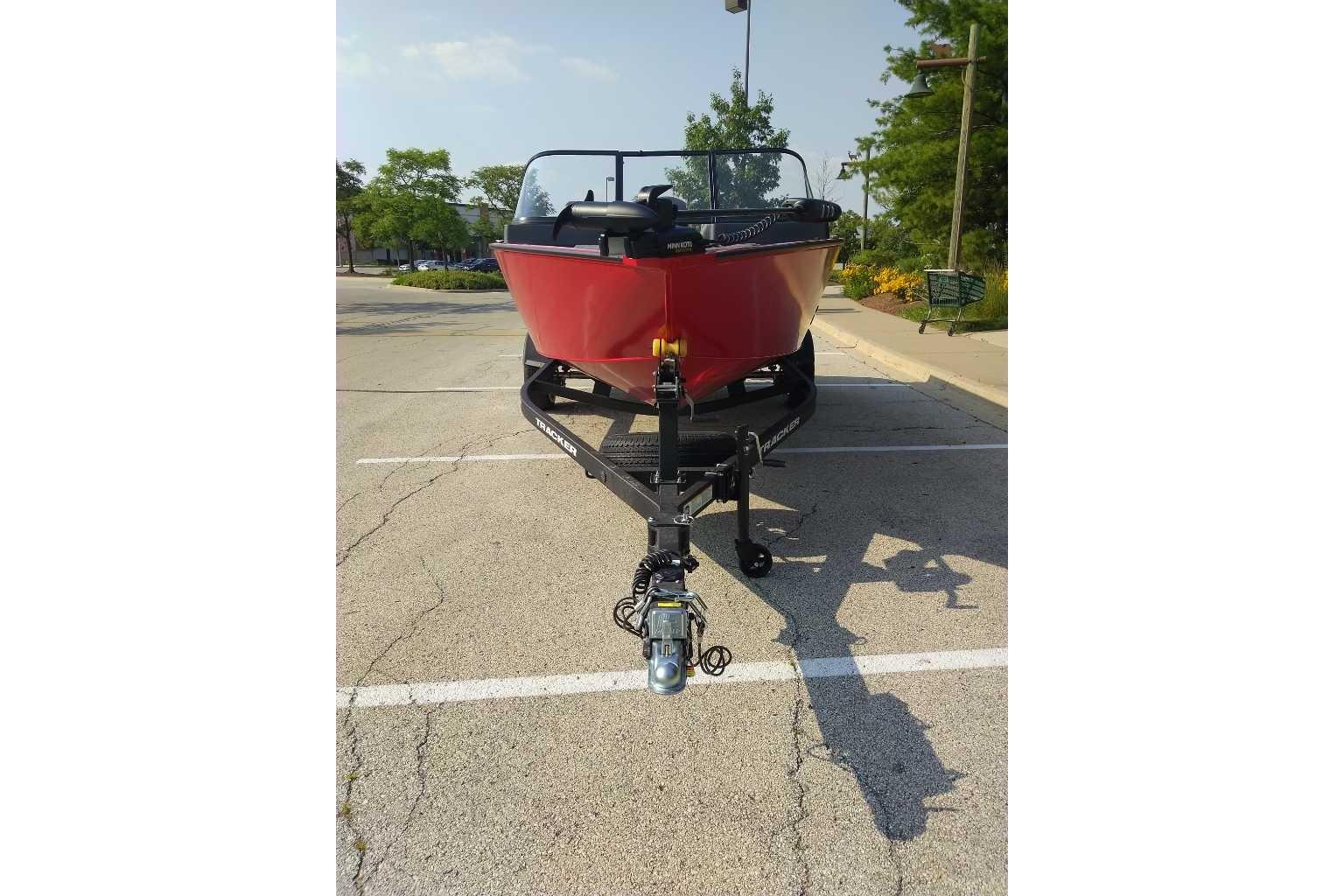 2026 Tracker Pro Guide V-175 WT boat on trailer in parking lot.