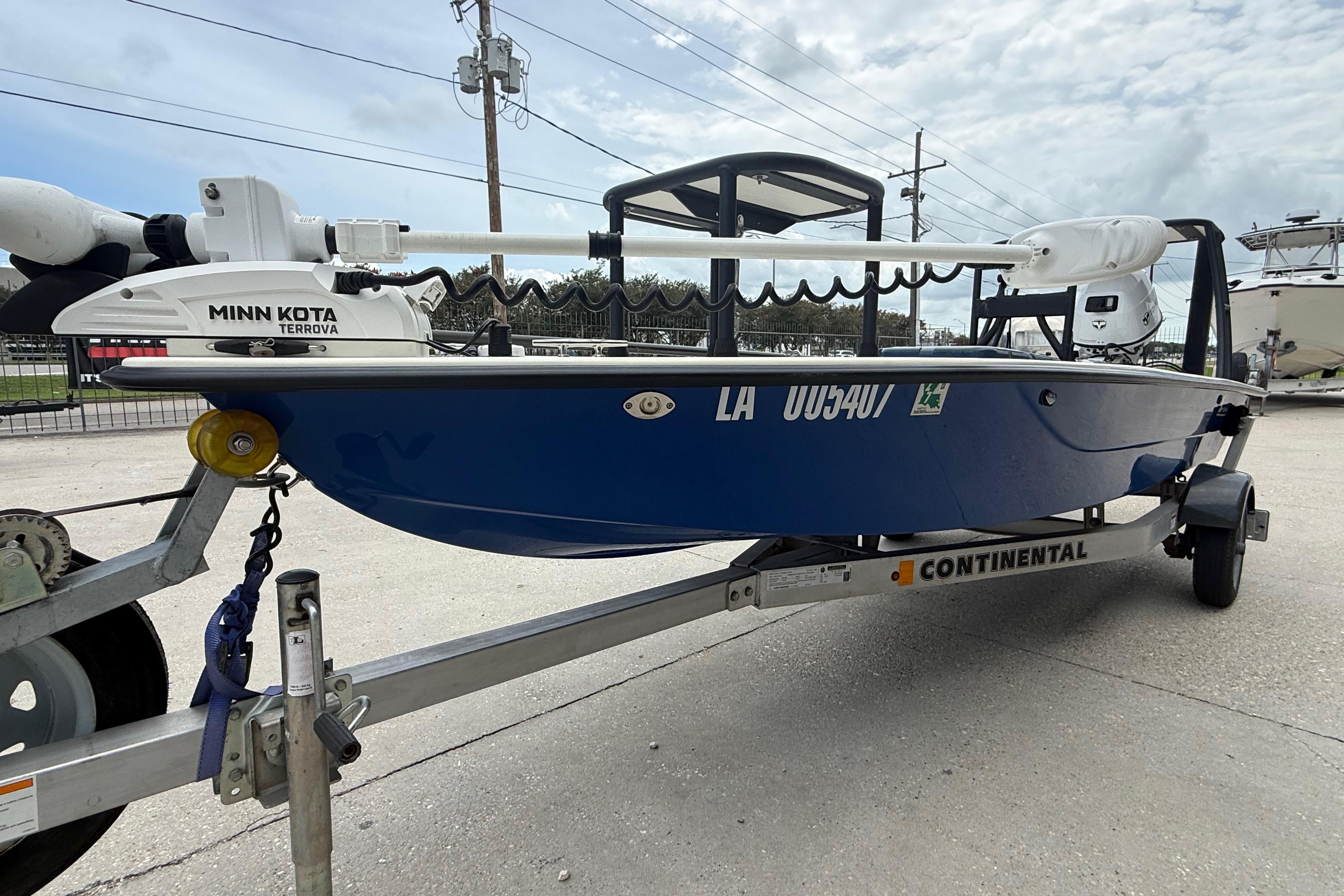 2020 Skimmer Skiff 14 boat on trailer with Minn Kota Terrova motor, parked outdoors.