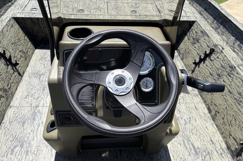 Steering console of 2026 Tracker Grizzly 2072 CC boat with gauges and controls.