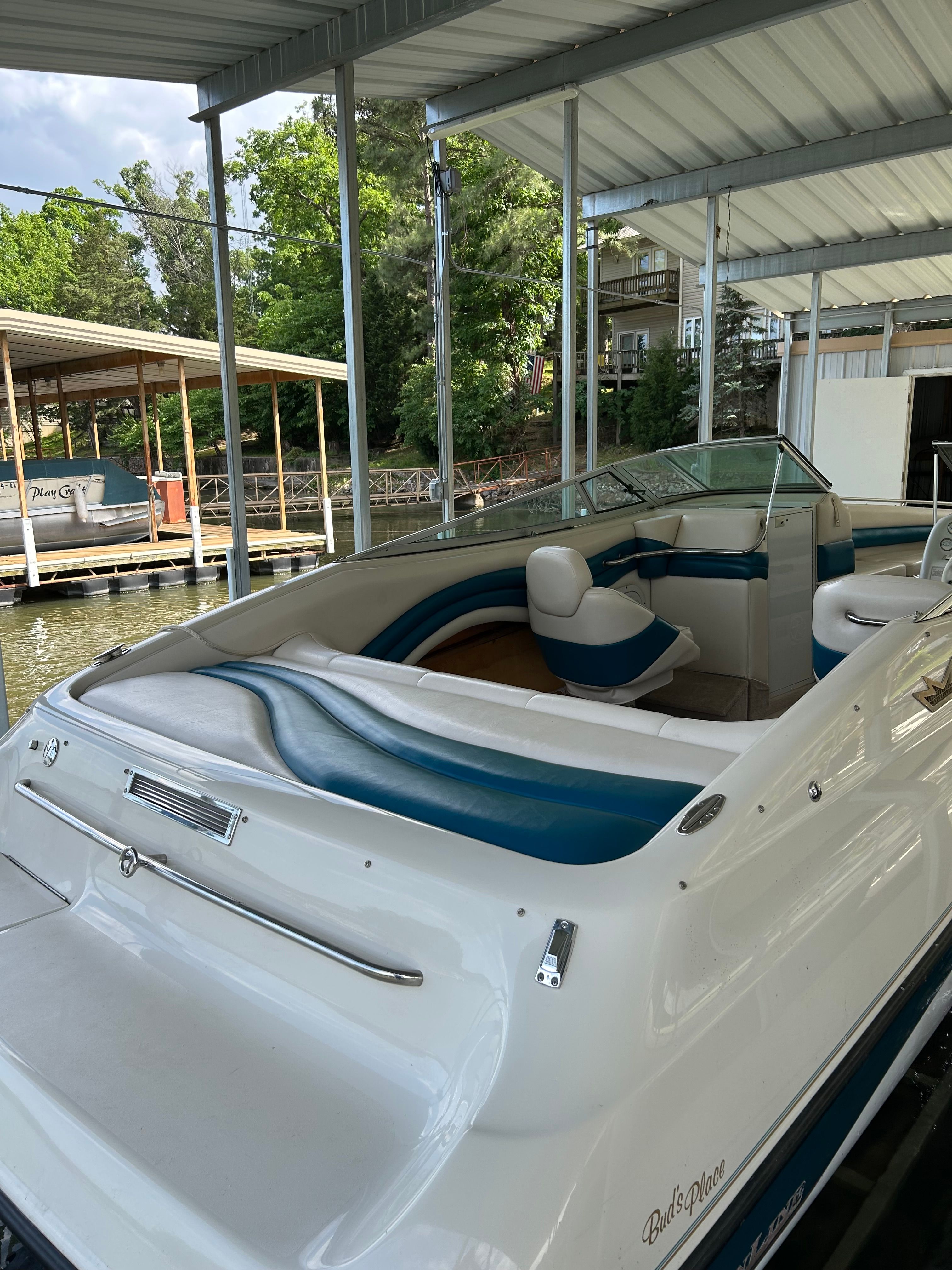 1995 Crownline 266 BR boat docked, featuring white and blue interior.