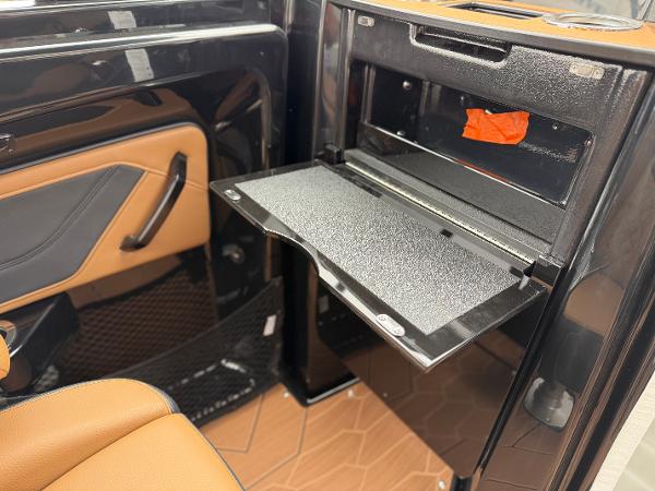 2025 Yamaha Boats 255XD interior with storage compartment and sleek design.