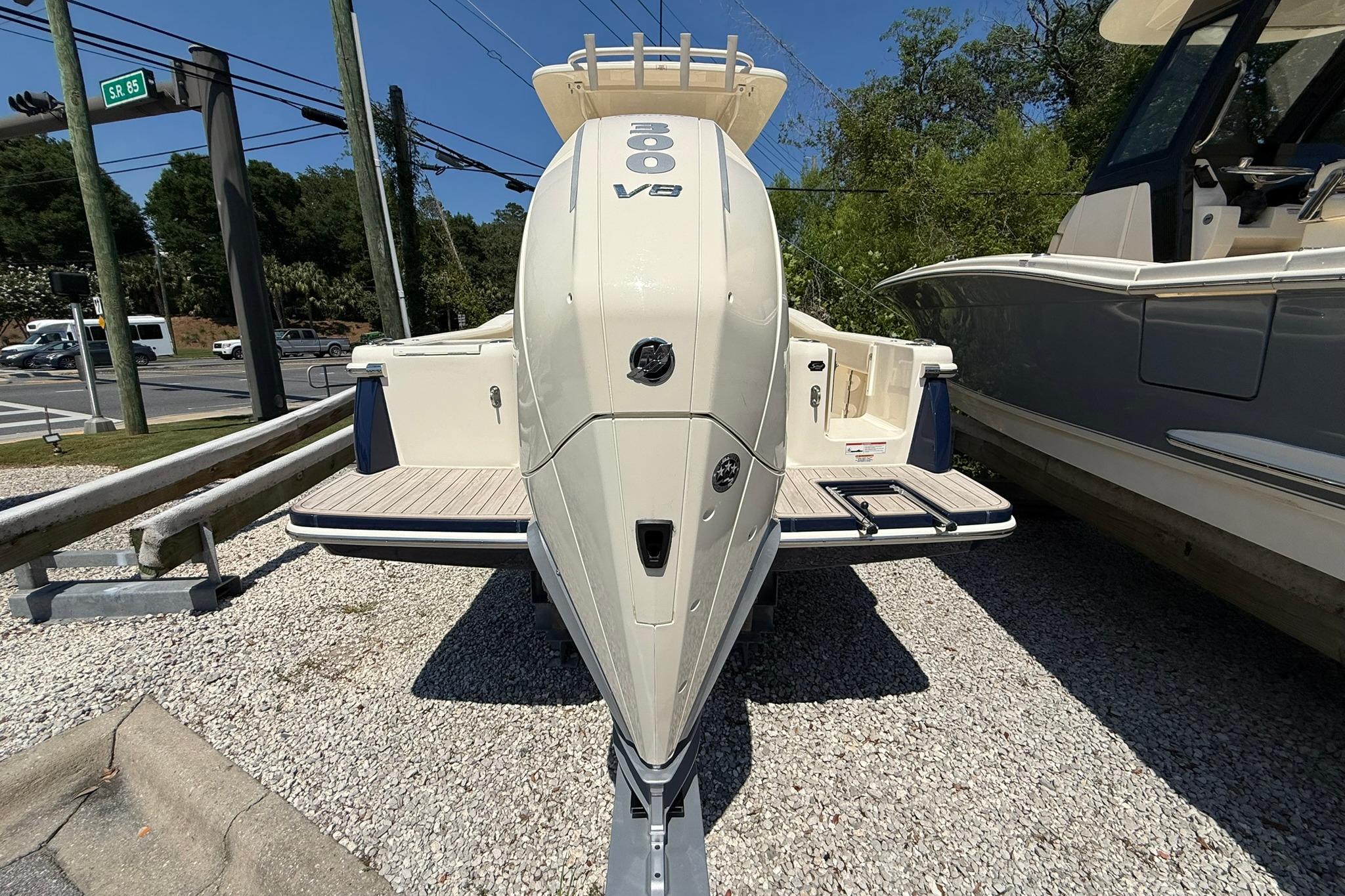 2027 Scout 240 XSF boat with powerful V8 engine displayed outdoors.