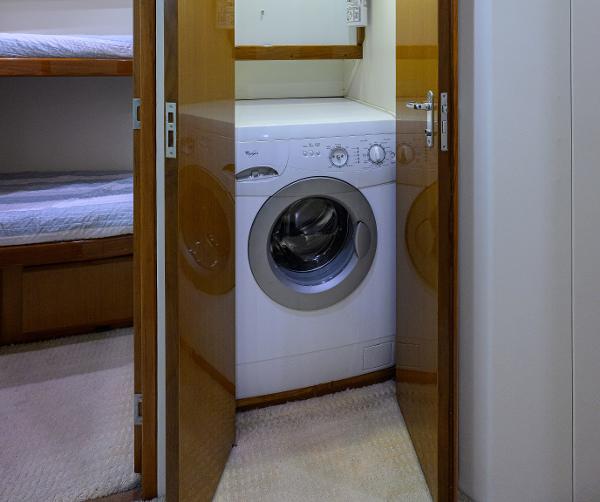 Laundry area with washer in 2000 Viking 50 Convertible yacht interior.