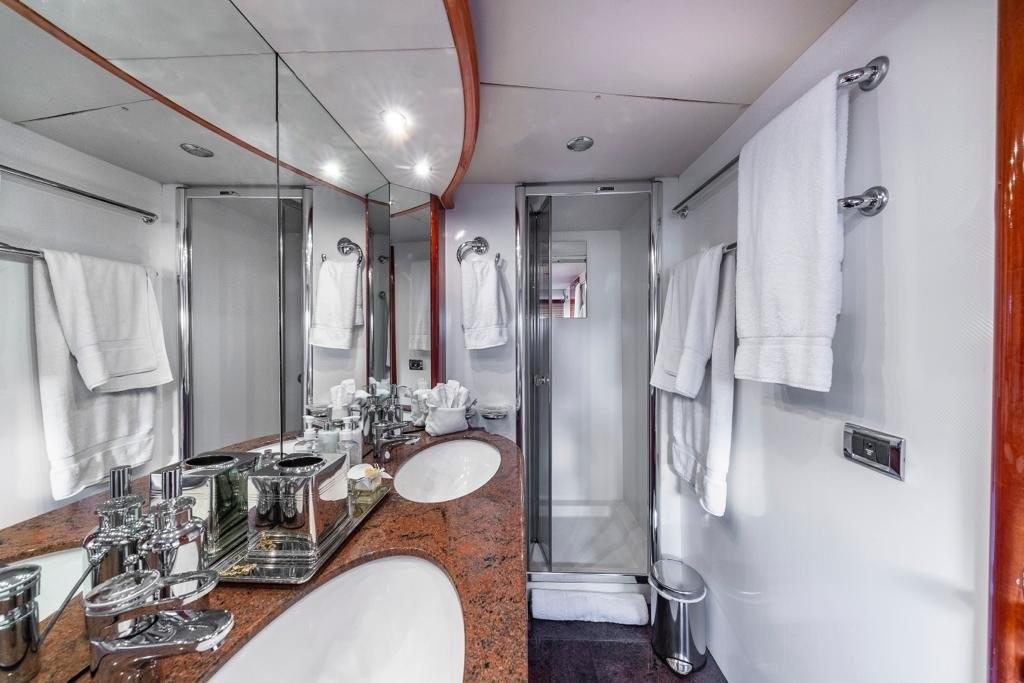 Luxurious bathroom in 2003 Sunseeker 82 Yacht with elegant fixtures and mirrored walls.