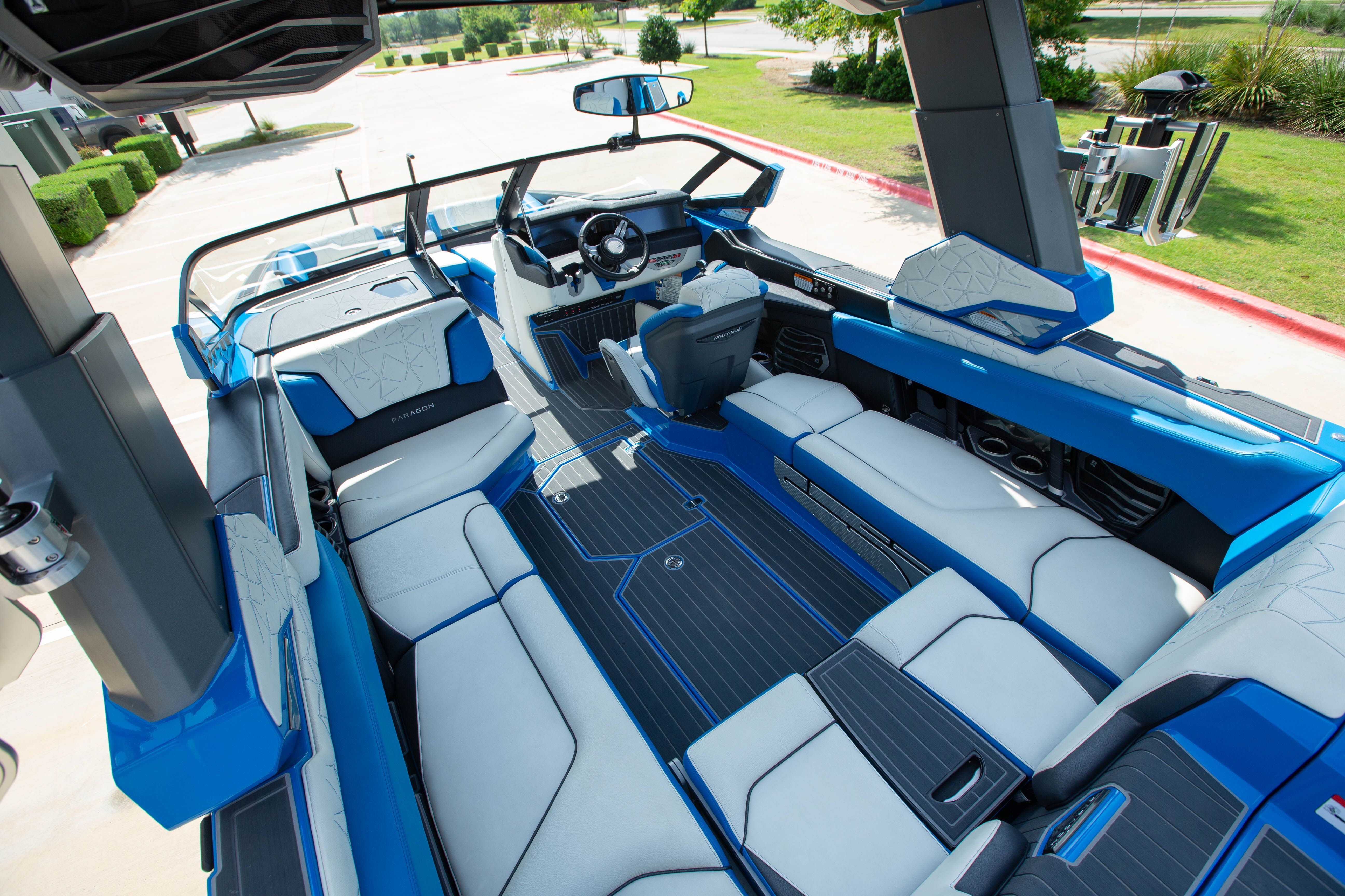 Interior view of a luxurious blue boat with white seating and modern design.