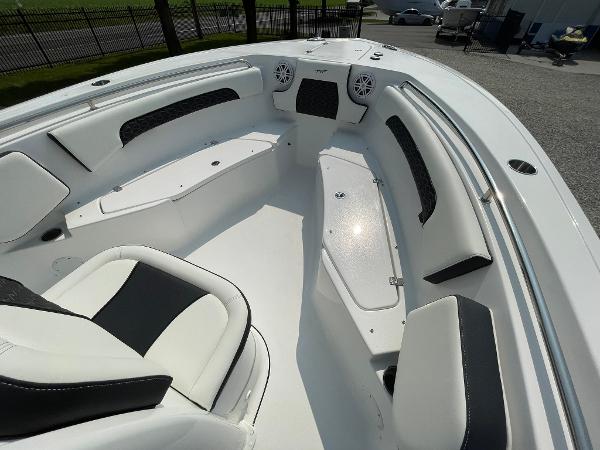 2025 Tidewater 232 CC Adventure boat interior with white seating and storage compartments.