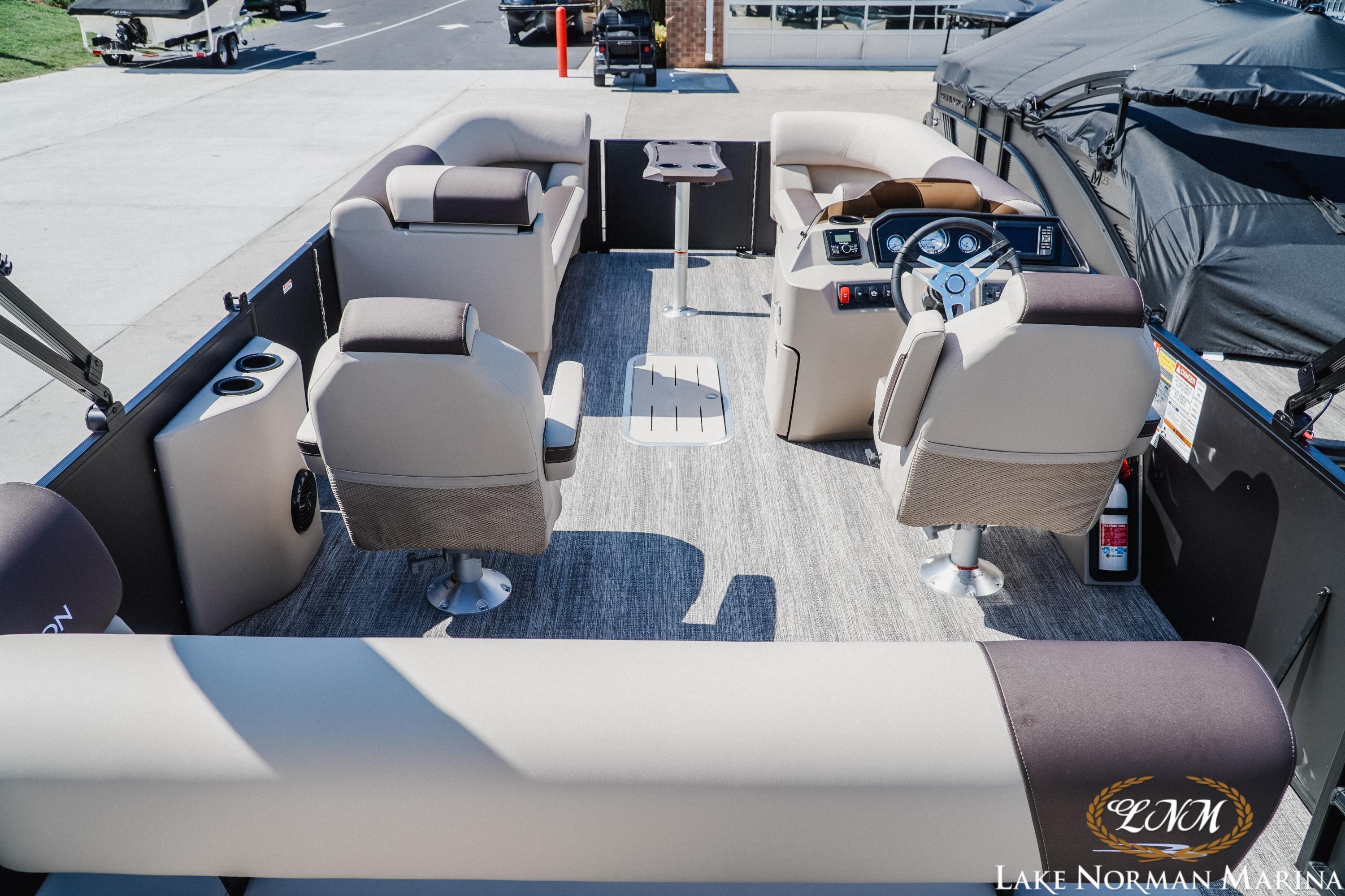 Interior of a 2027 Bennington 23ssb pontoon boat with plush seating and modern dashboard.